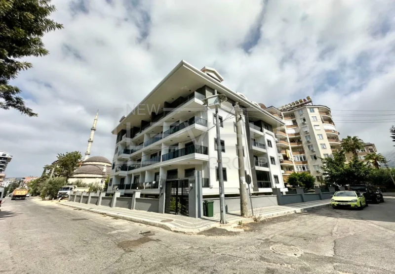 Beyaz gri köşe cepheli bina: Alanya’da satılık 1+1 daire, Türkiye’de — New Level Group