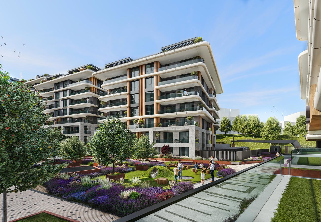 İstanbul’daki dairelerin bulunduğu sitede ağaçlı merkezi çim alan ve ahşap banklar