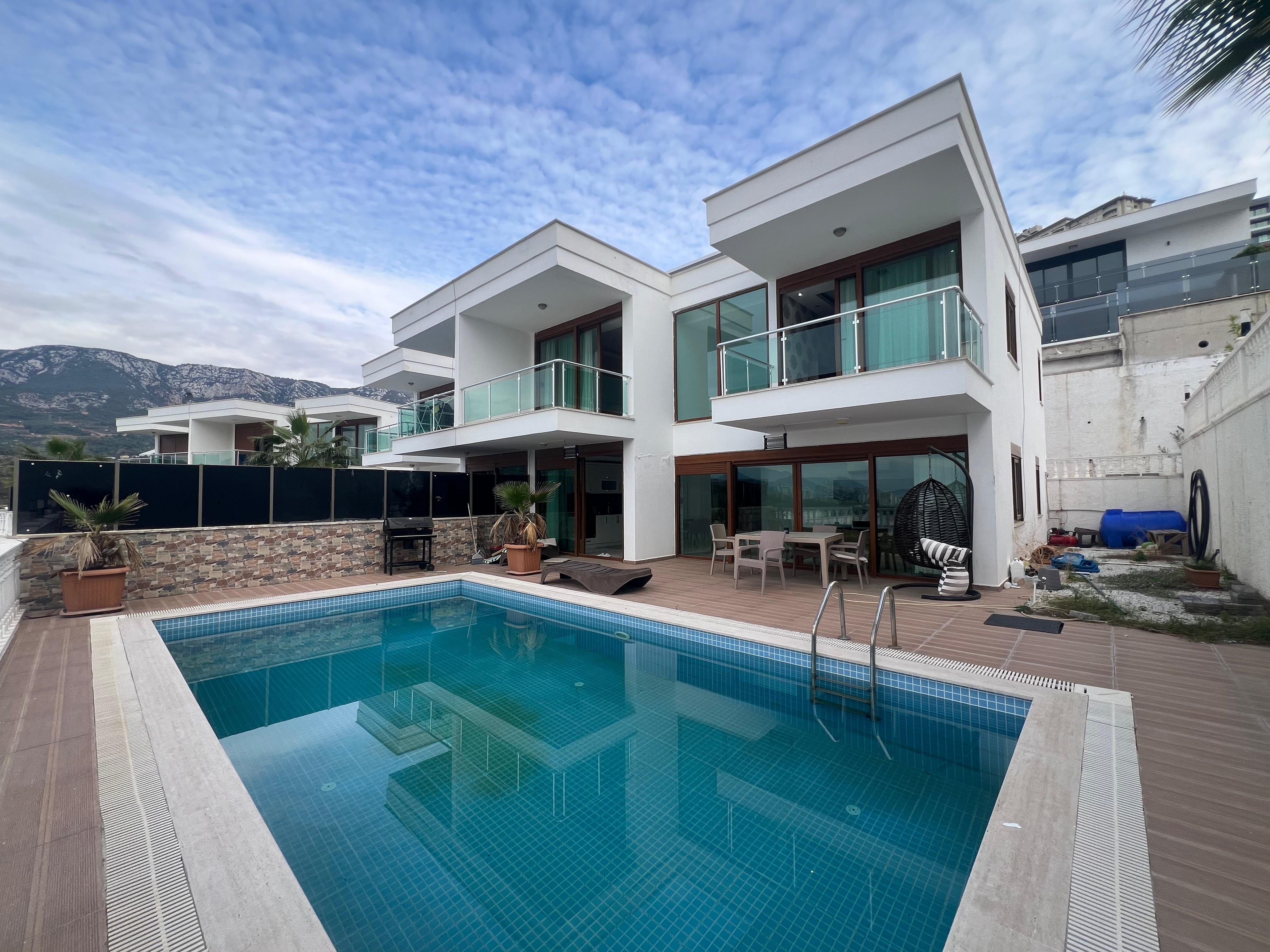 Pool beside a white two-storey villa: 3+1 villa for sale in Kargicak, Turkey — New Level Group