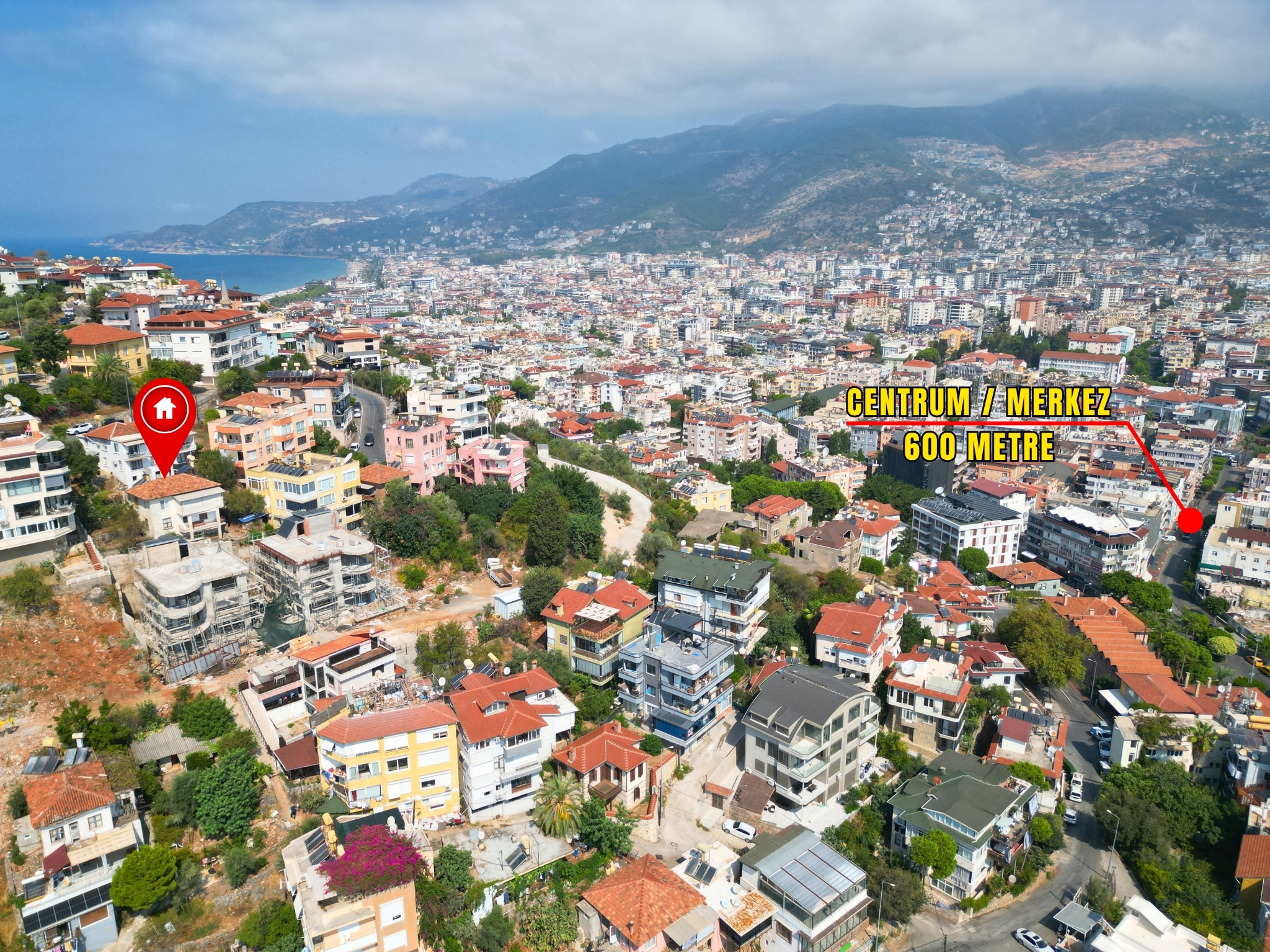 A city panorama with winding streets and mountain ridges shows a detached home for sale