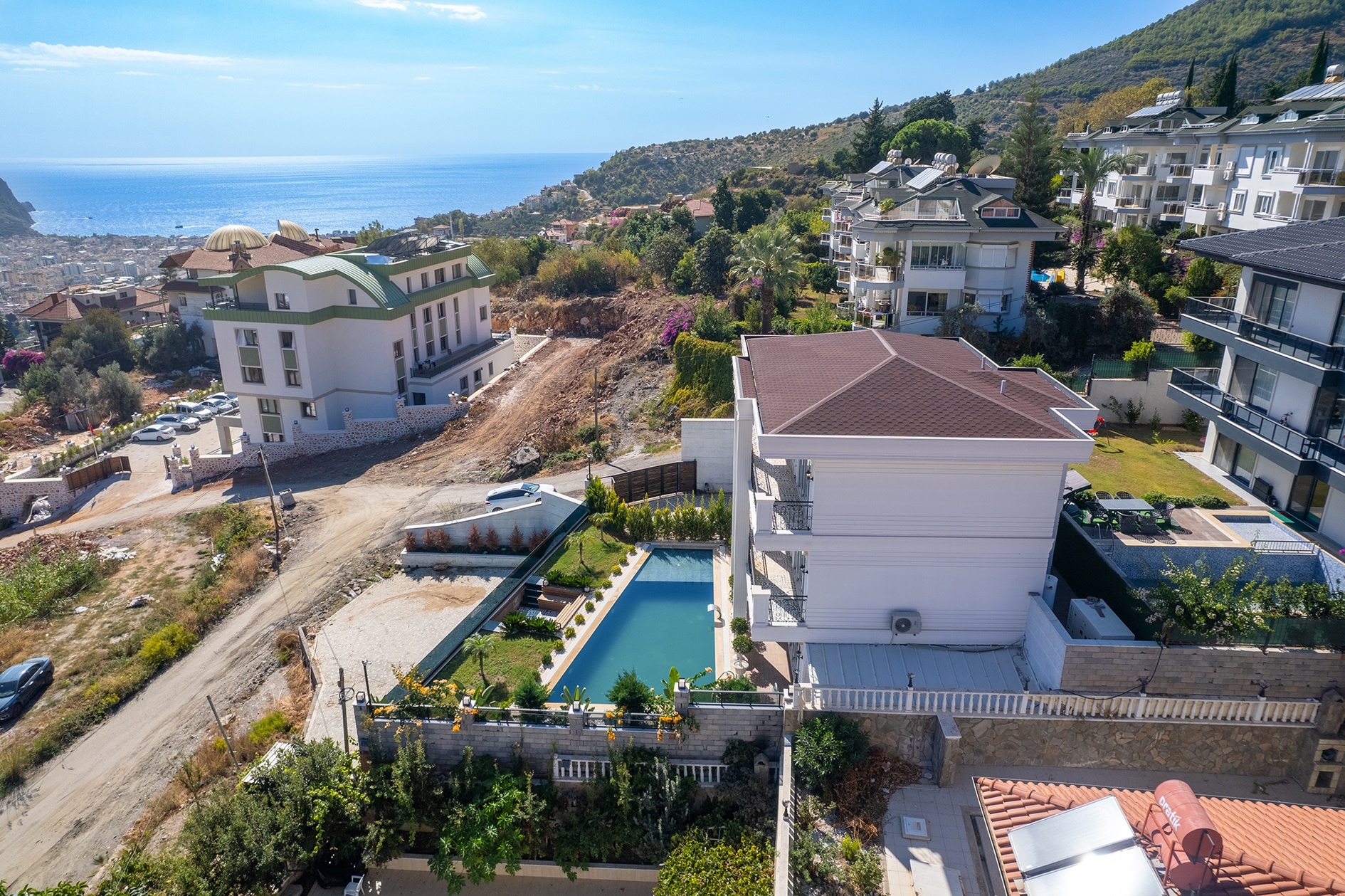 Villa with a pool on a fenced plot overlooking a sea bay and wooded mountains in Alanya