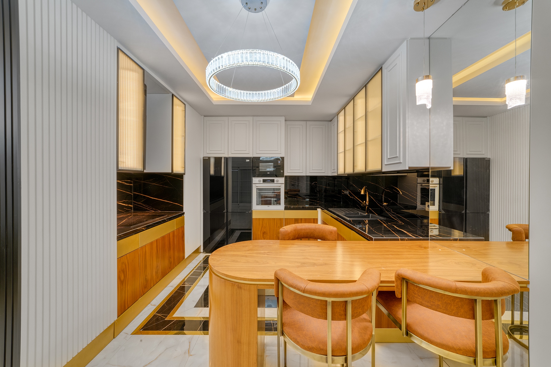 Built-in villa kitchen with white fronts, a black countertop and wooden dining counter
