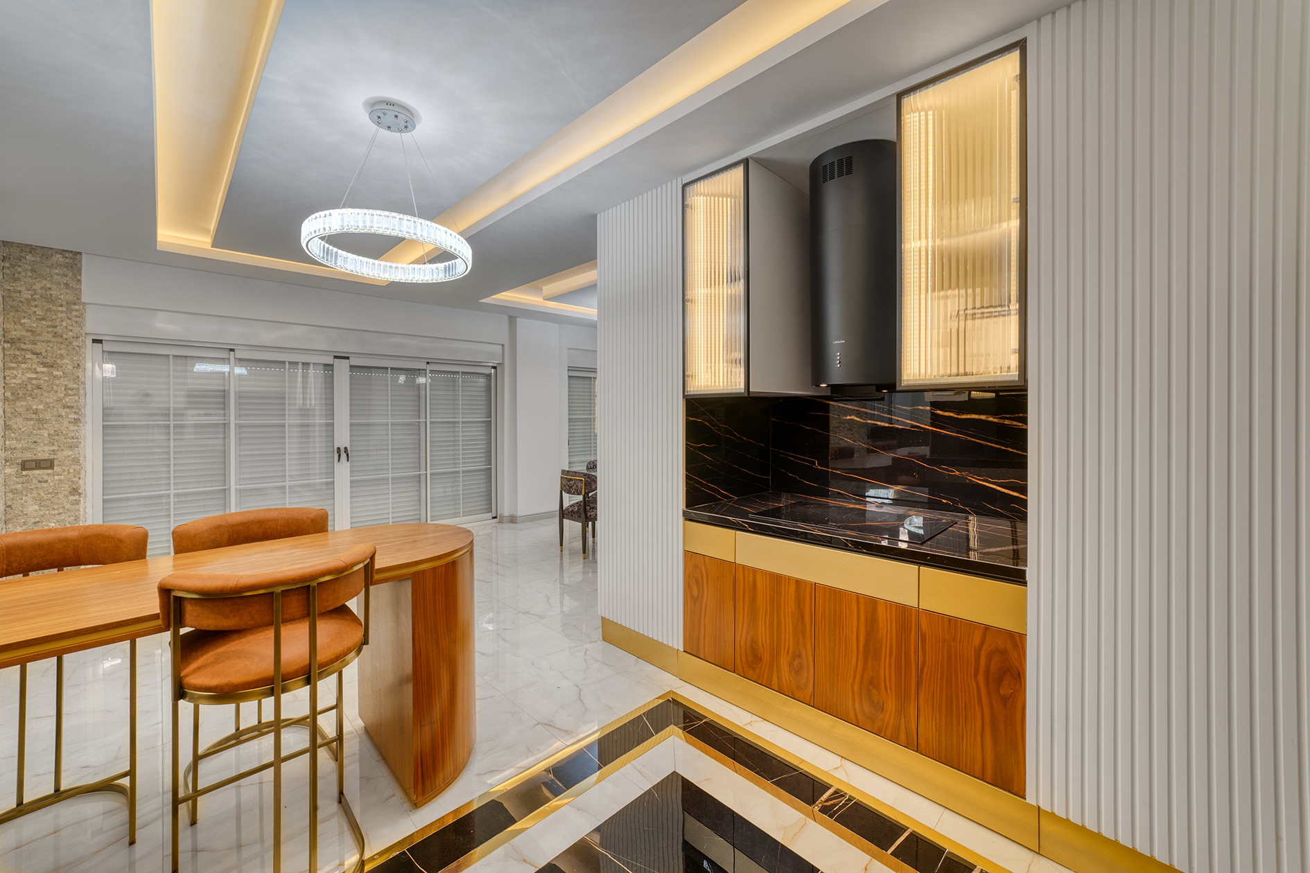 Corner house kitchen with wood fronts, white cabinets and panoramic sliding doors