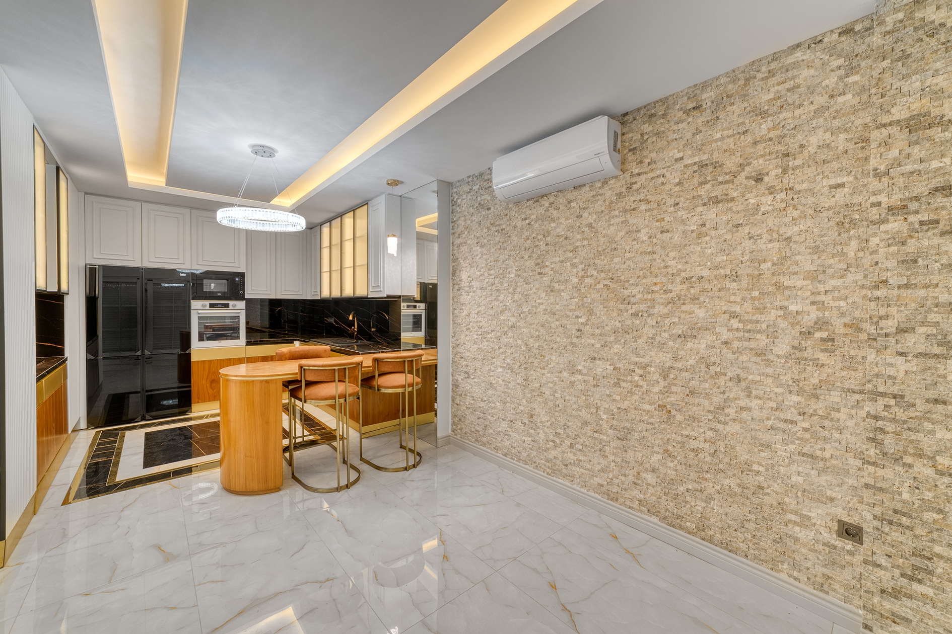 Villa dining area with a wooden counter, black cabinetry and beige stone wall in Alanya, Turkey