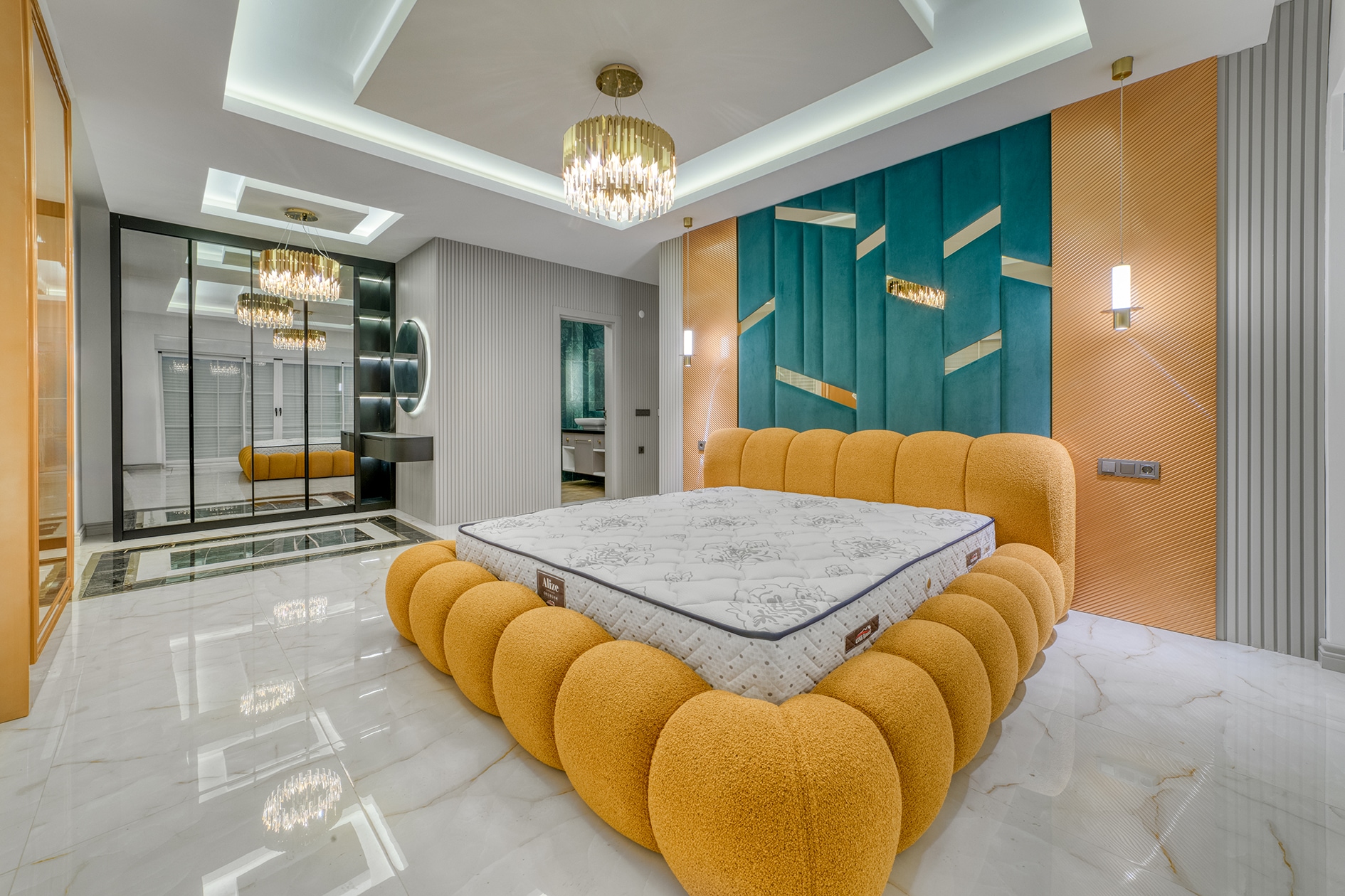 House bedroom with an orange bed, turquoise panel and mirrored wardrobes in Alanya