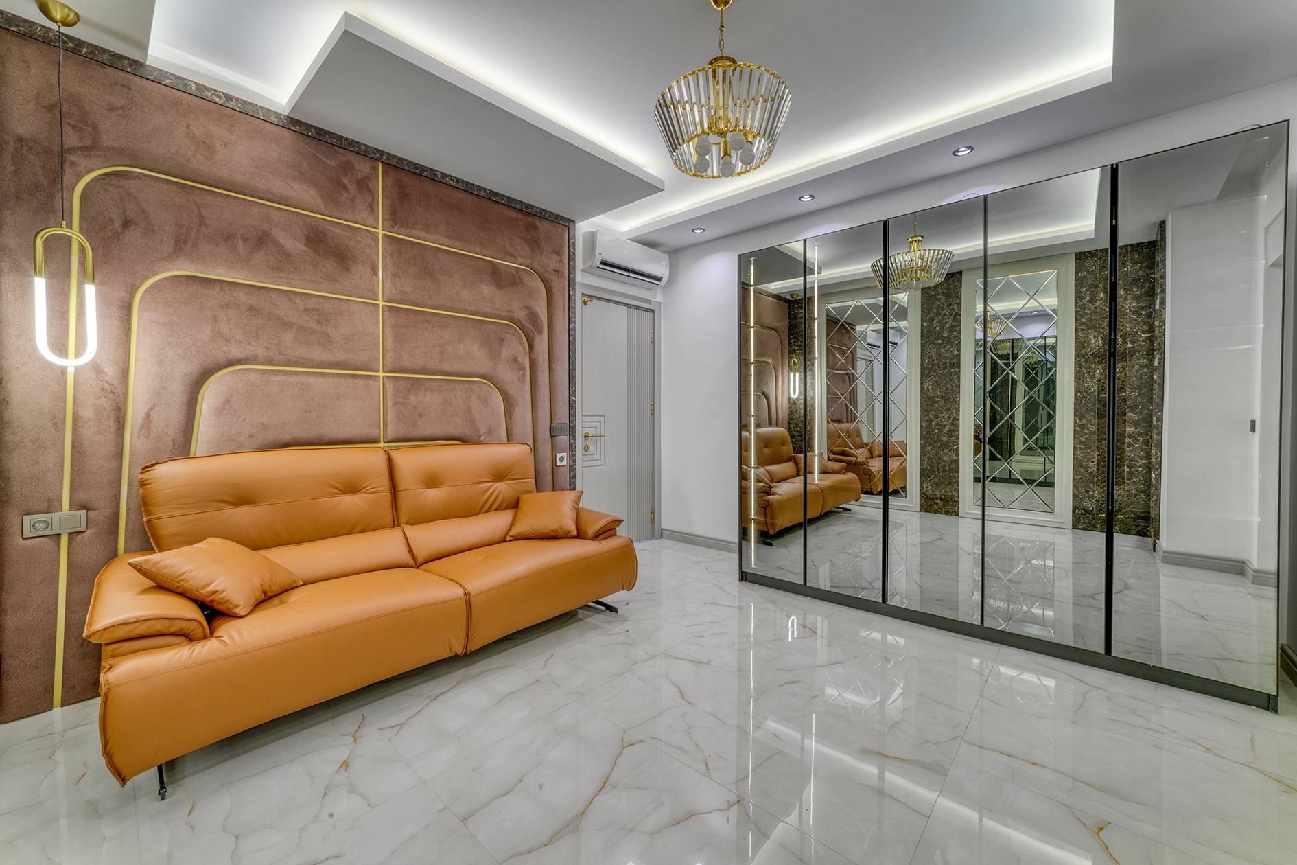 Orange leather sofa beside a brown wall panel in a house living room in Alanya