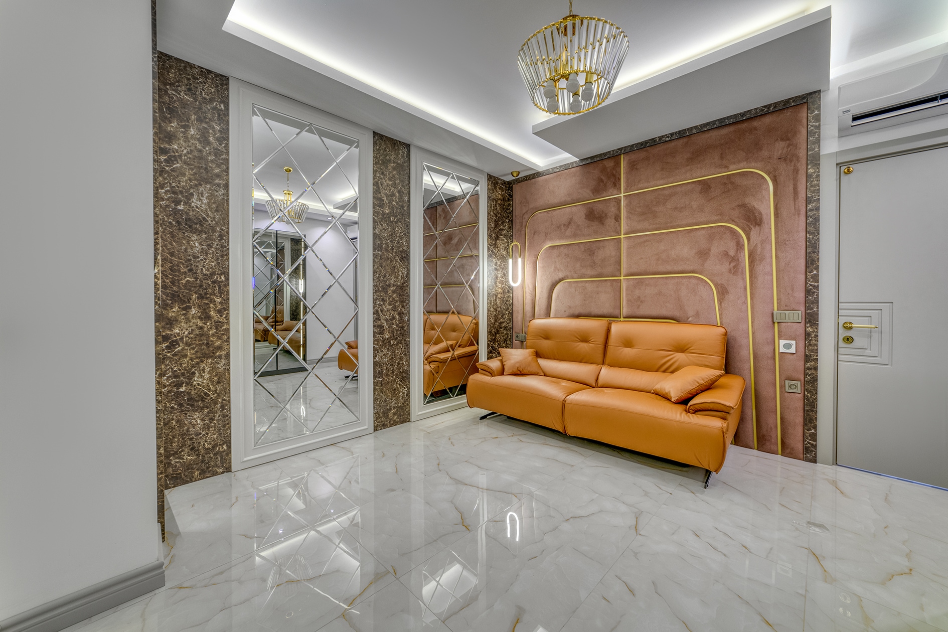 Orange leather sofa and diamond-patterned mirrored panels in a living room in Turkey