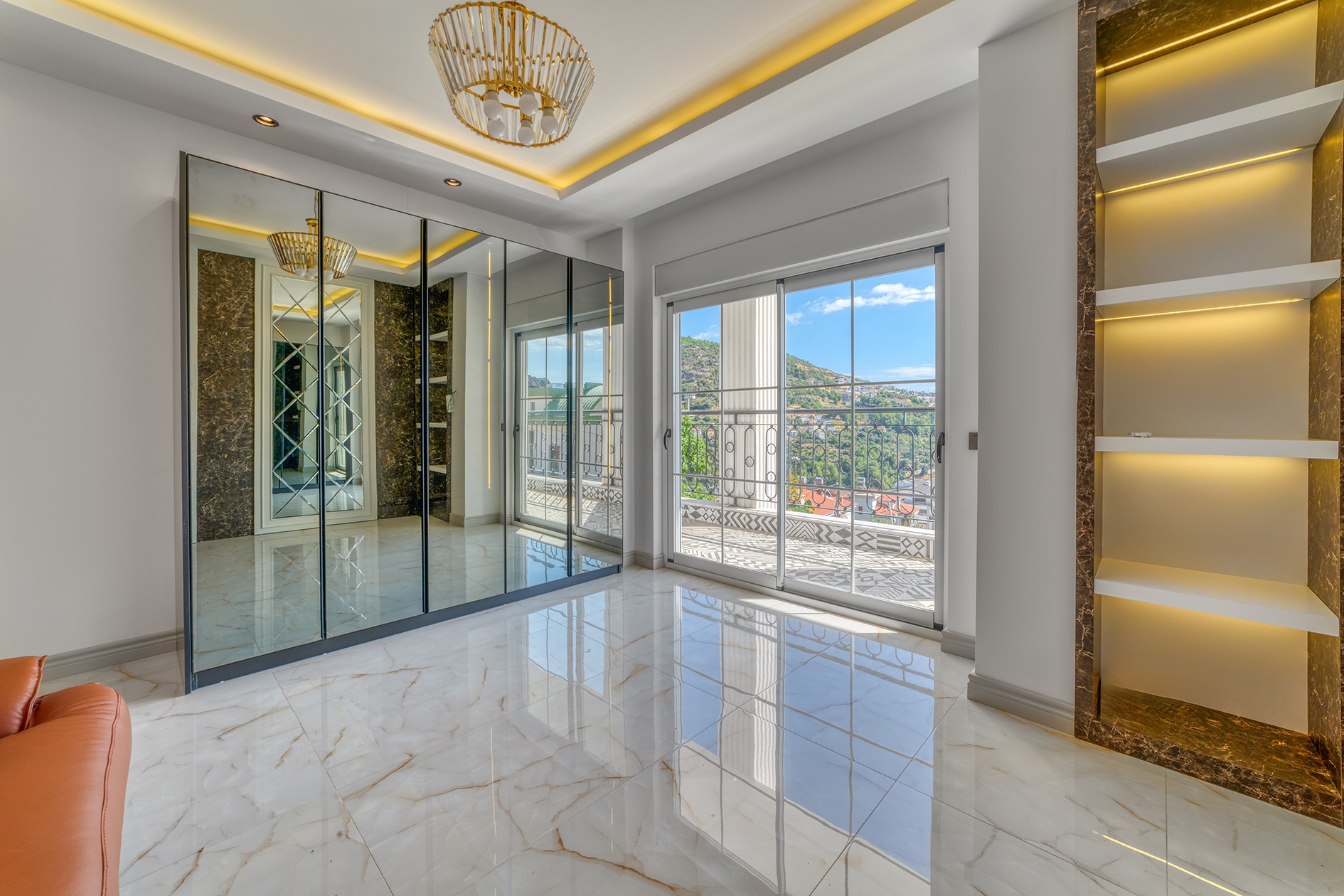 Panoramic sliding window and orange corner sofa in a villa in Turkey
