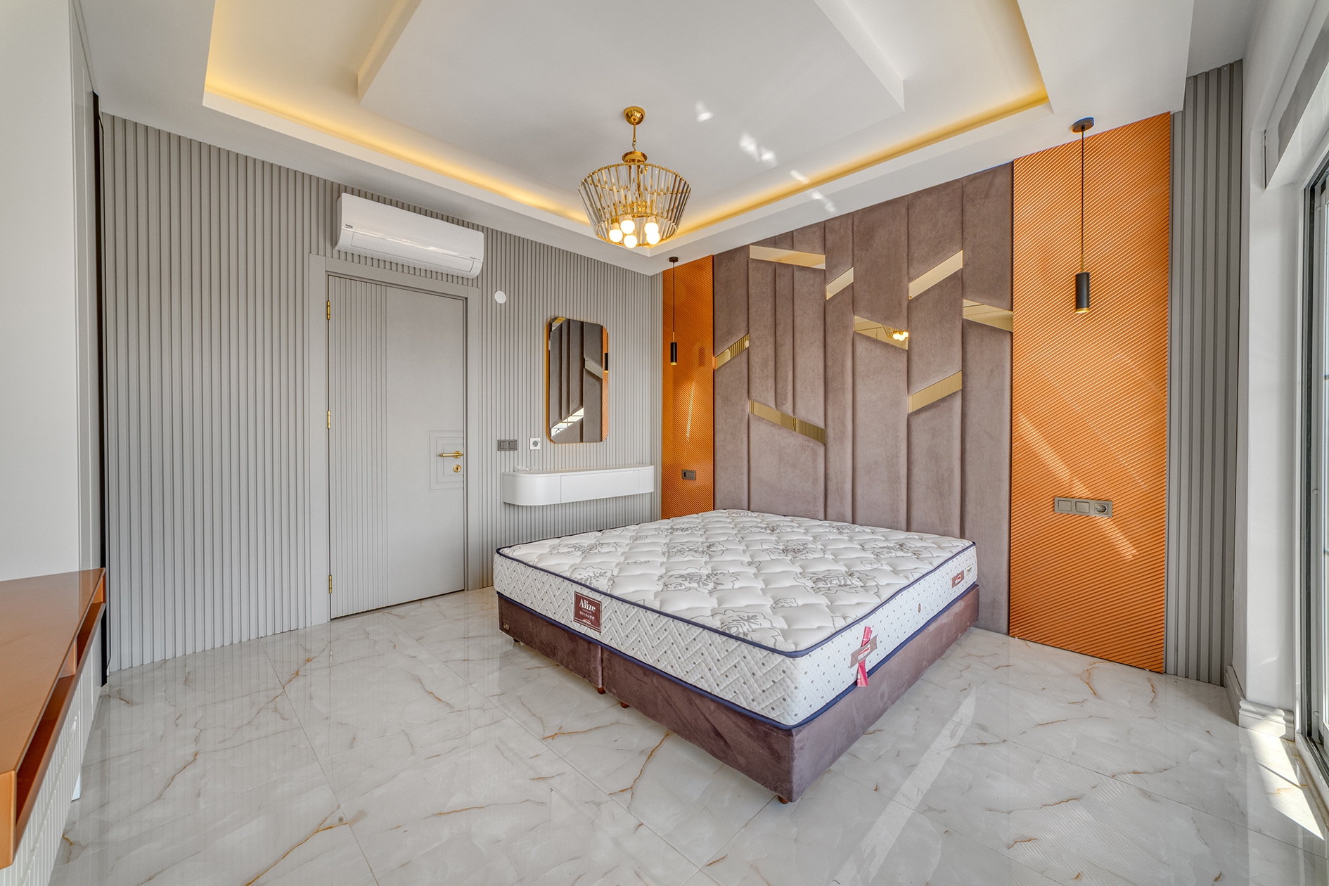Double bed beside textured wall panels and a white console in a house bedroom