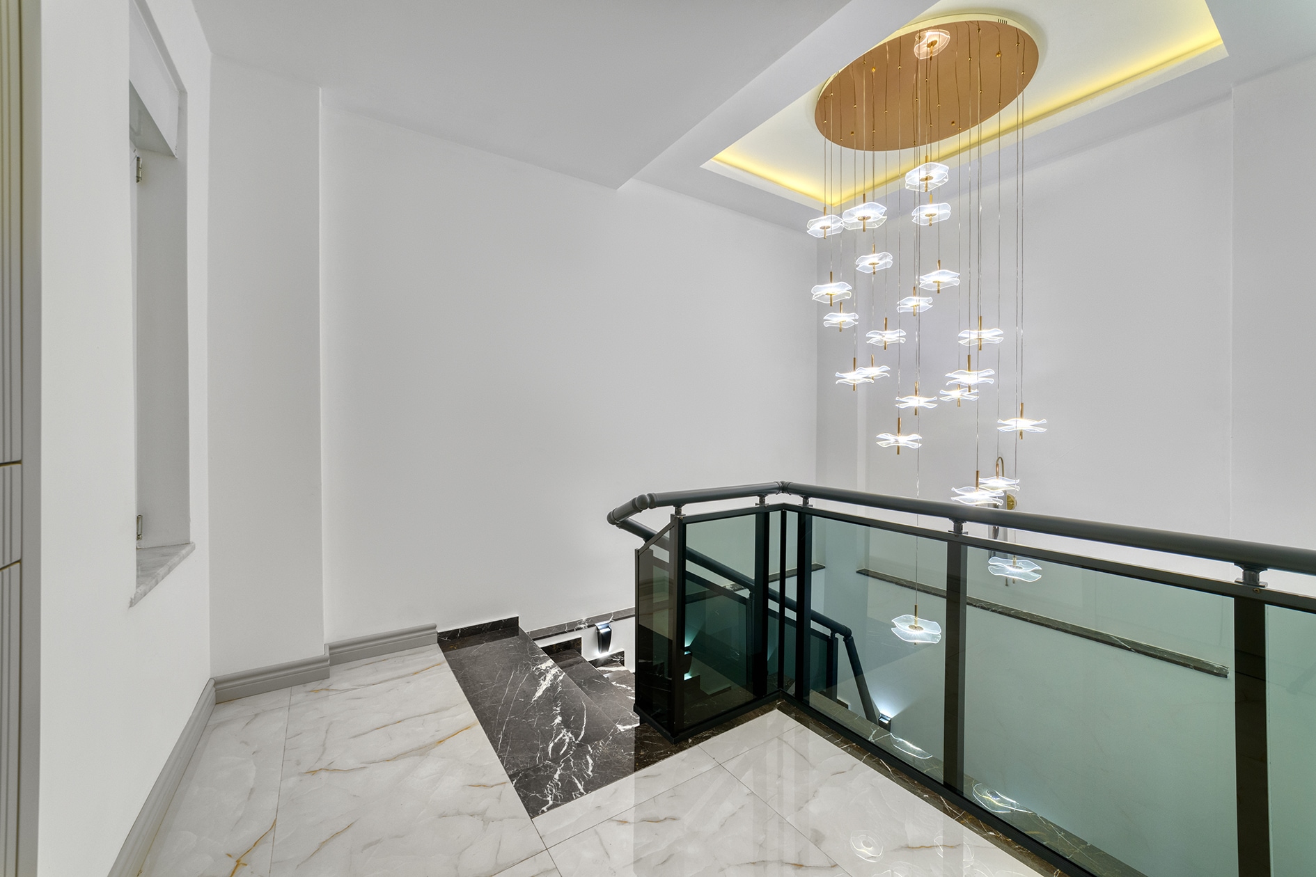 Stairwell with a black marble insert and glass balustrade
