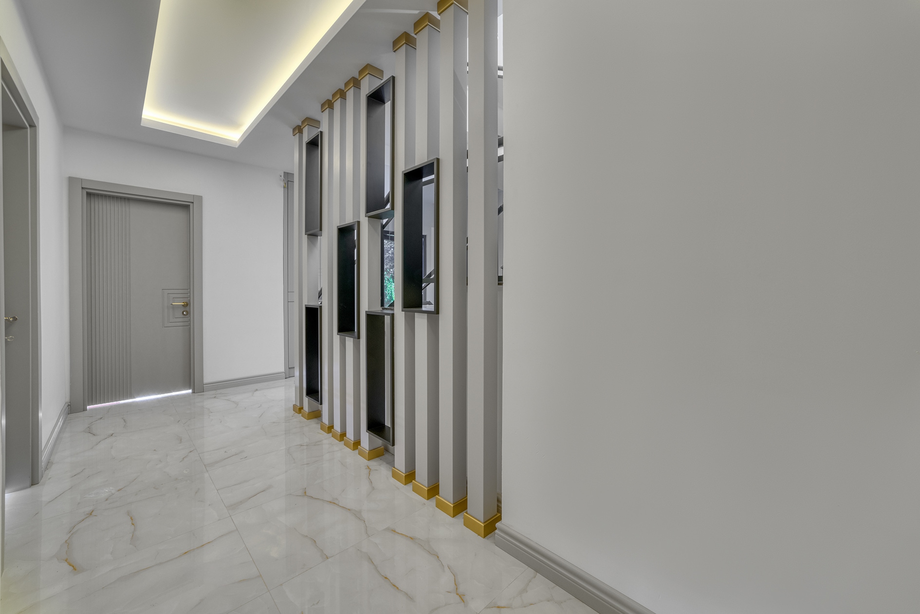 White marble floor and vertical slatted wall panel in a villa hall