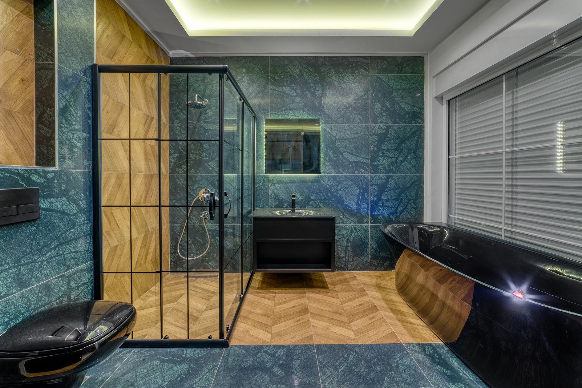 Black freestanding bathtub and vanity beside a framed shower in a villa bathroom
