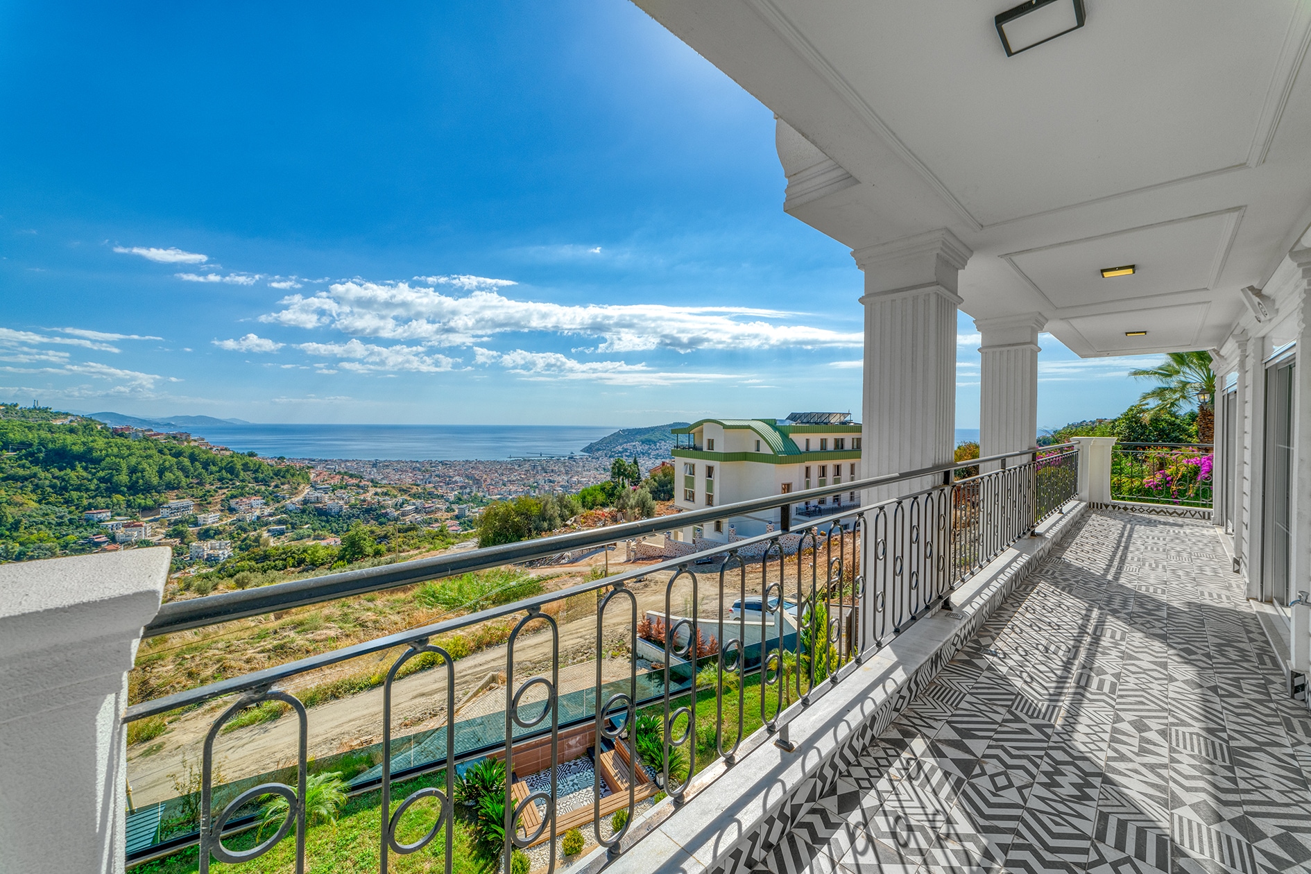 Covered terrace with columns and panoramic sea views where a villa is for sale