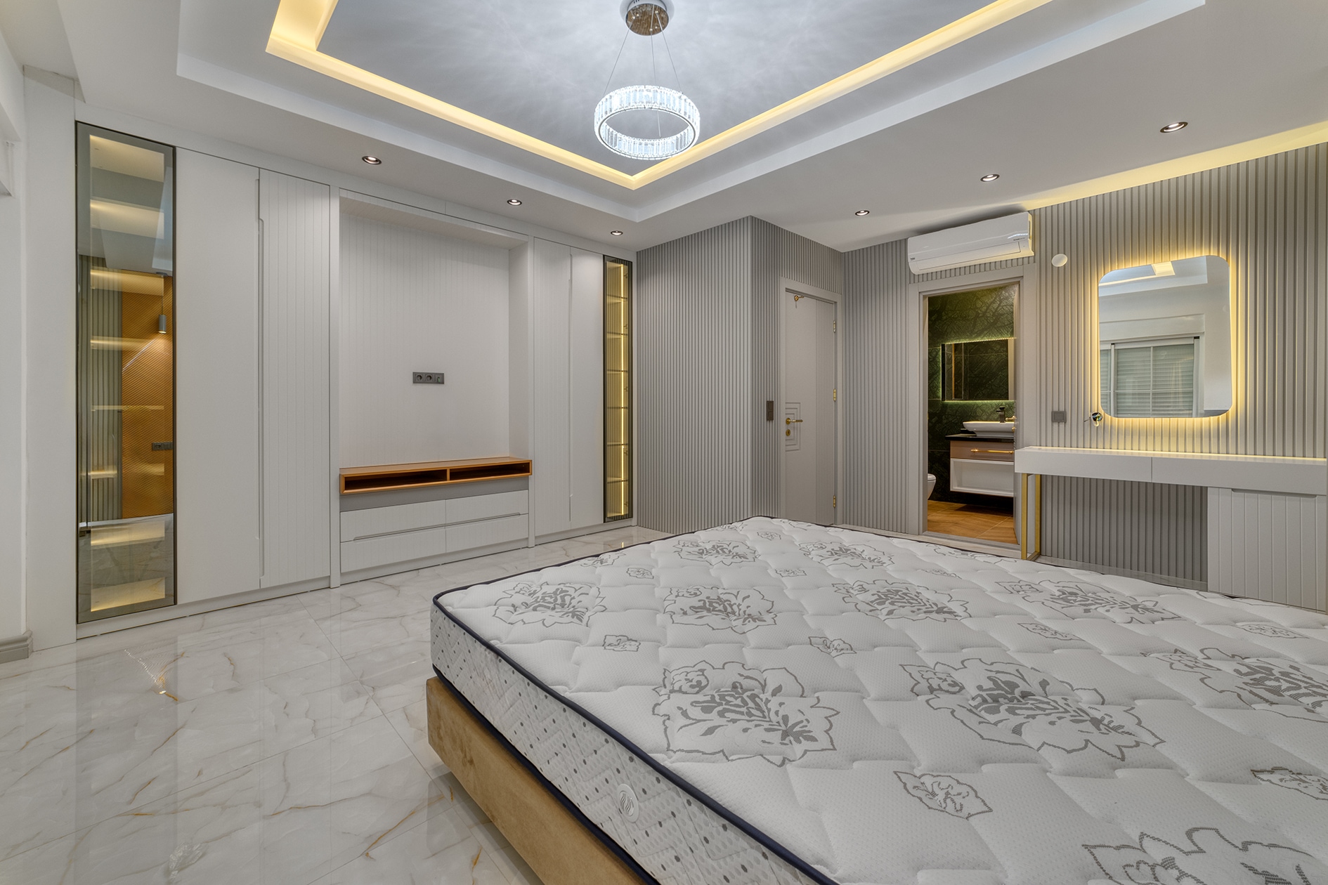 Double bed with mirrored wardrobe and dressing table in a villa bedroom in Alanya