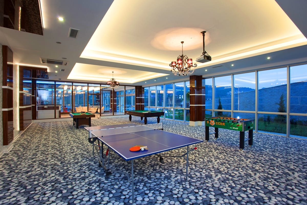 Table tennis, billiards and table football in a sports area for residents of villas in Kargicak