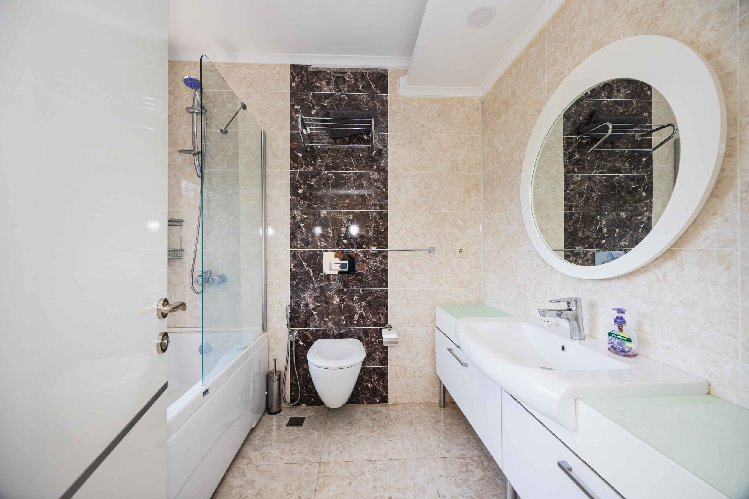 Bathroom with shower screen, bathtub and marble finishes in a villa in Kargicak