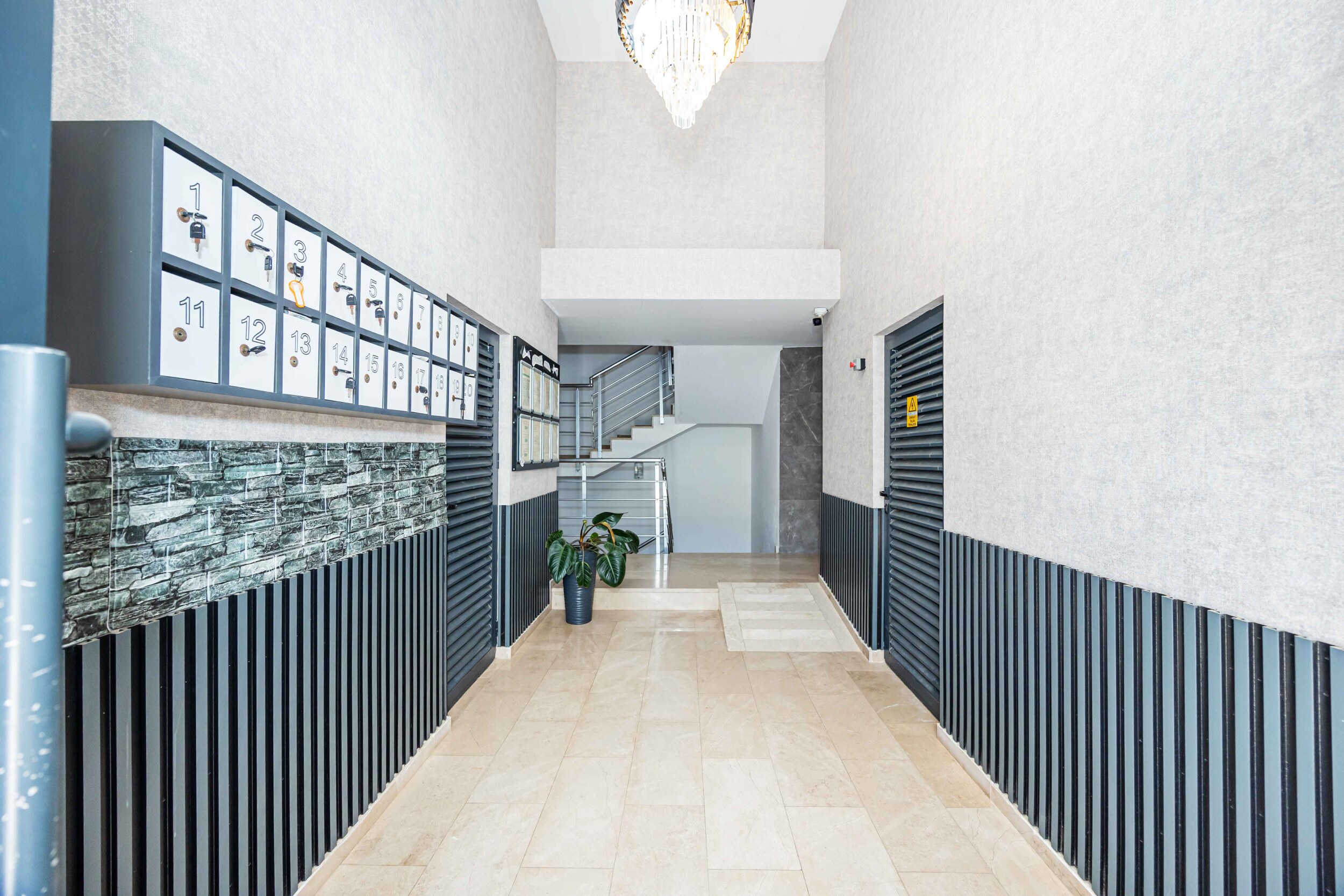 Mailboxes and a marble floor in the lobby of a residence with top-floor apartments