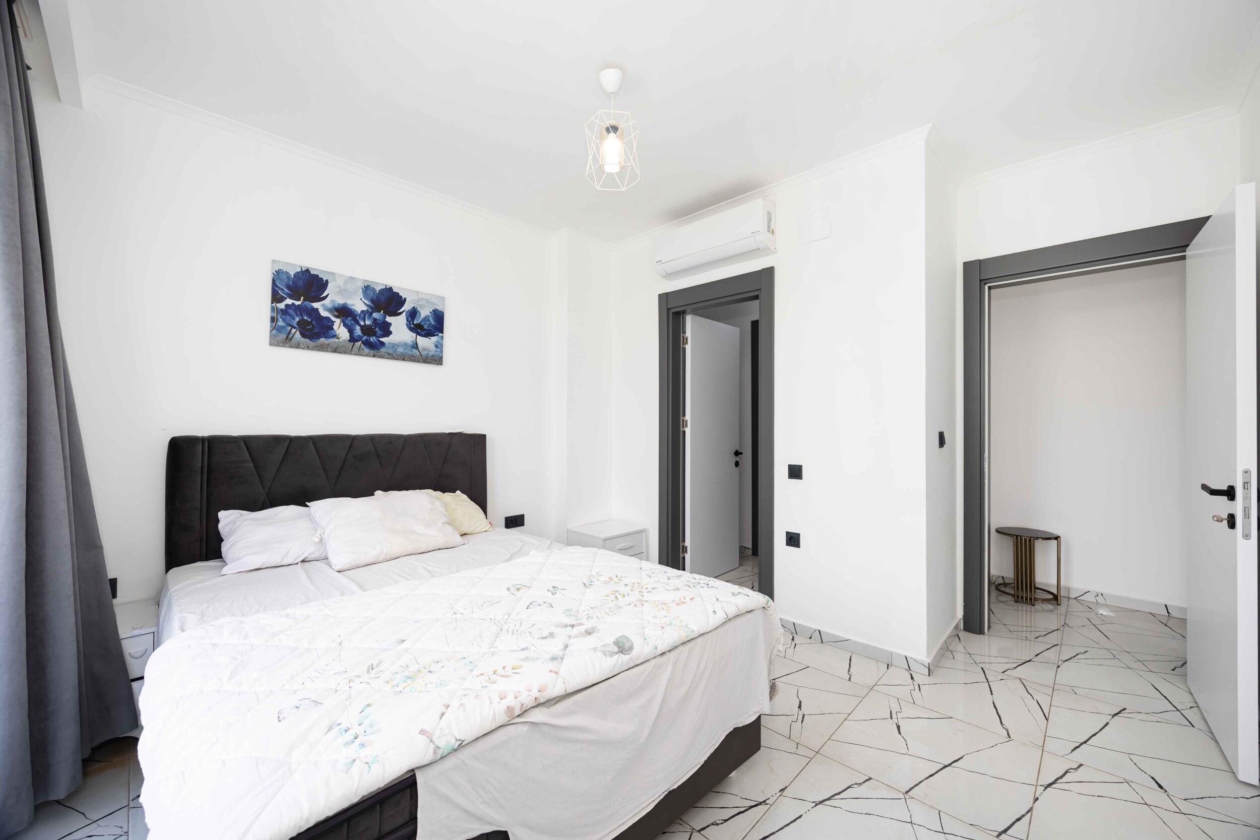 Bedroom with double bed, artwork and built-in wardrobe in a duplex in Kargicak