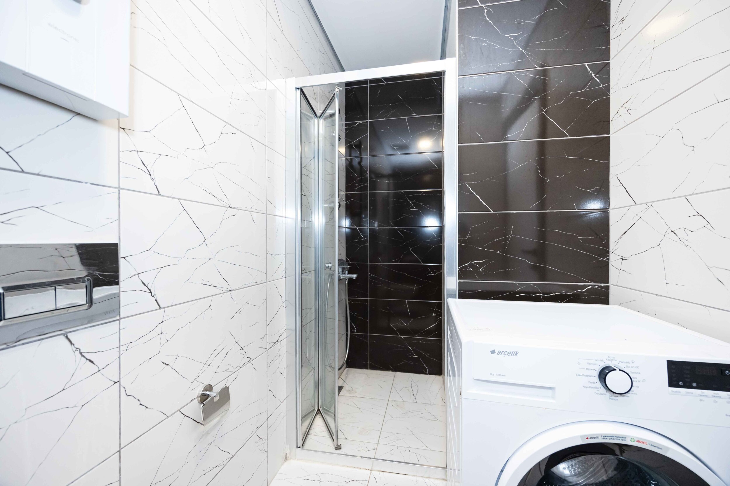 Glass shower enclosure and marble finish in a penthouse in Kargicak