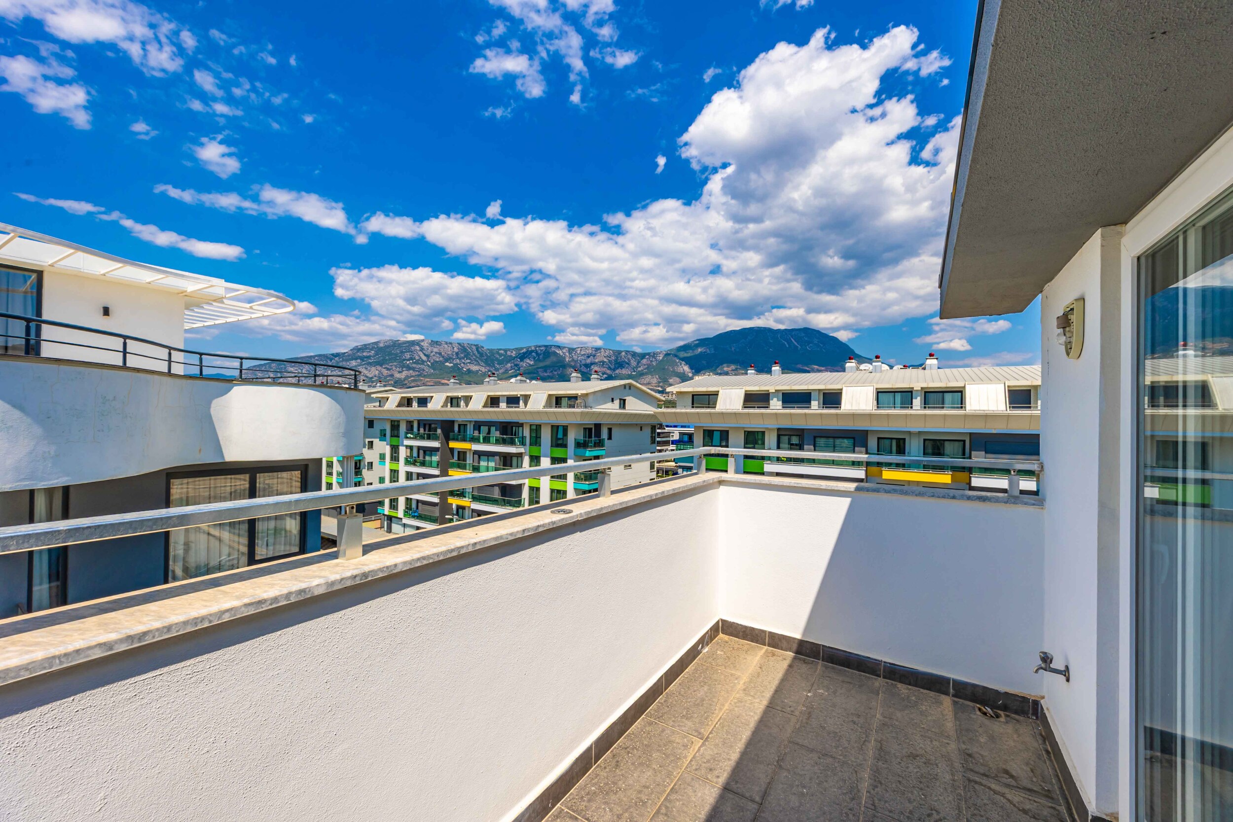 Terrace with glass railing and mountain ridge in Kargicak