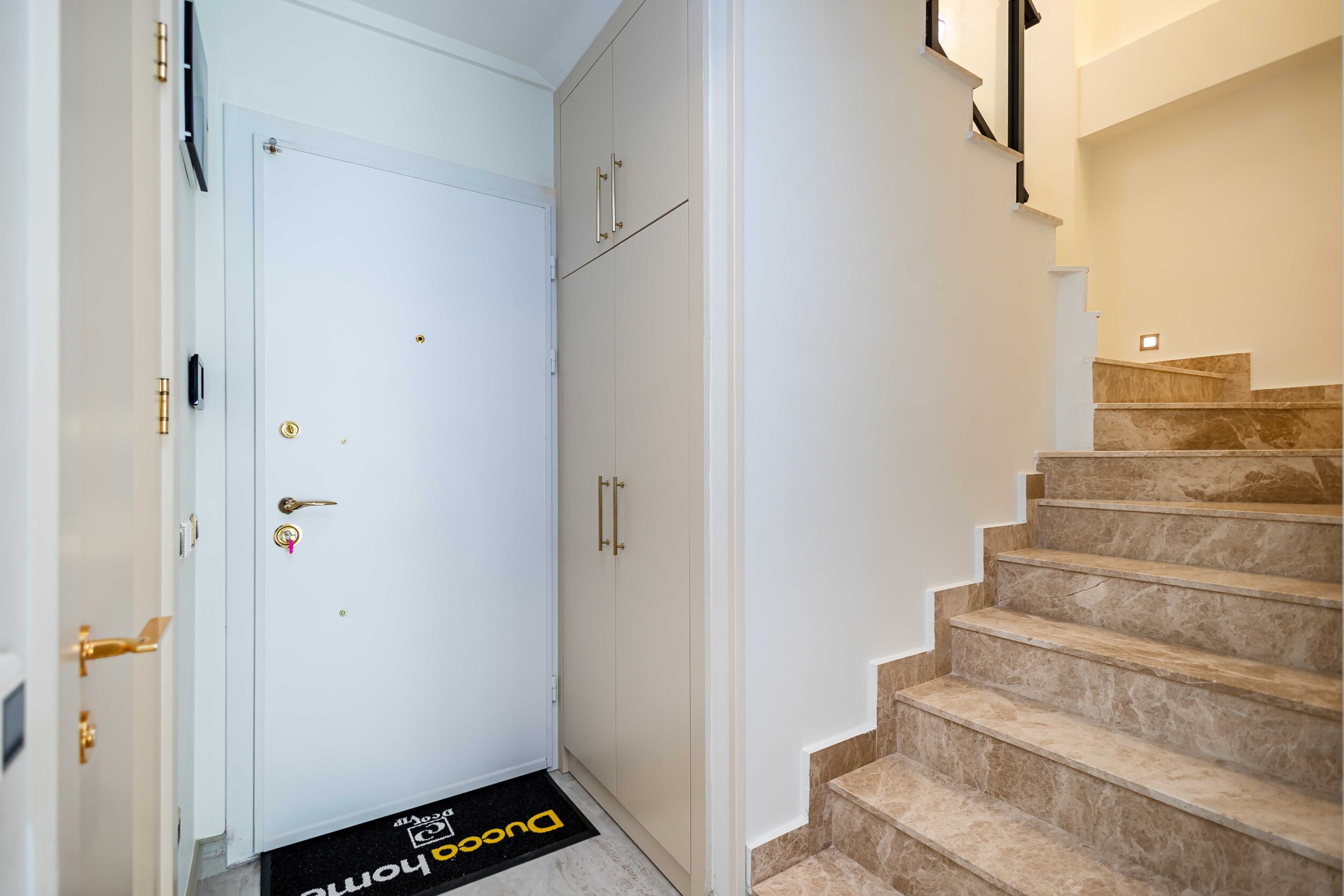 Stairwell with marble steps and built-in storage in a residence by the sea