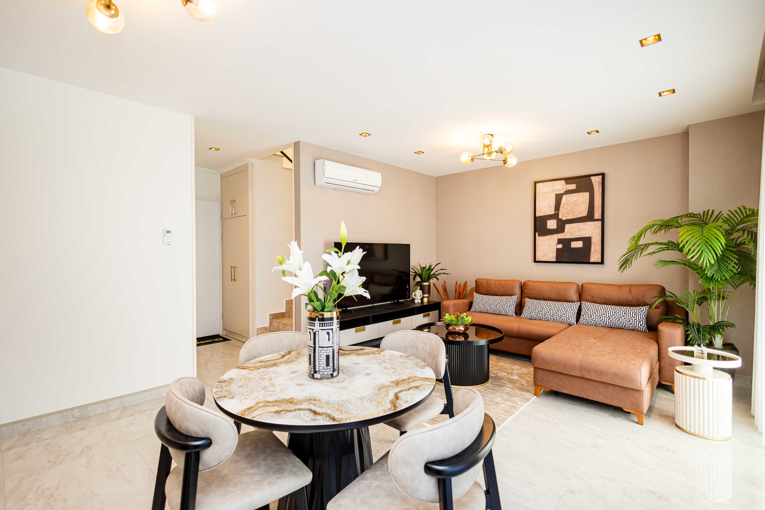 Kitchen-living room with a dining table and panoramic window in a residence for sale