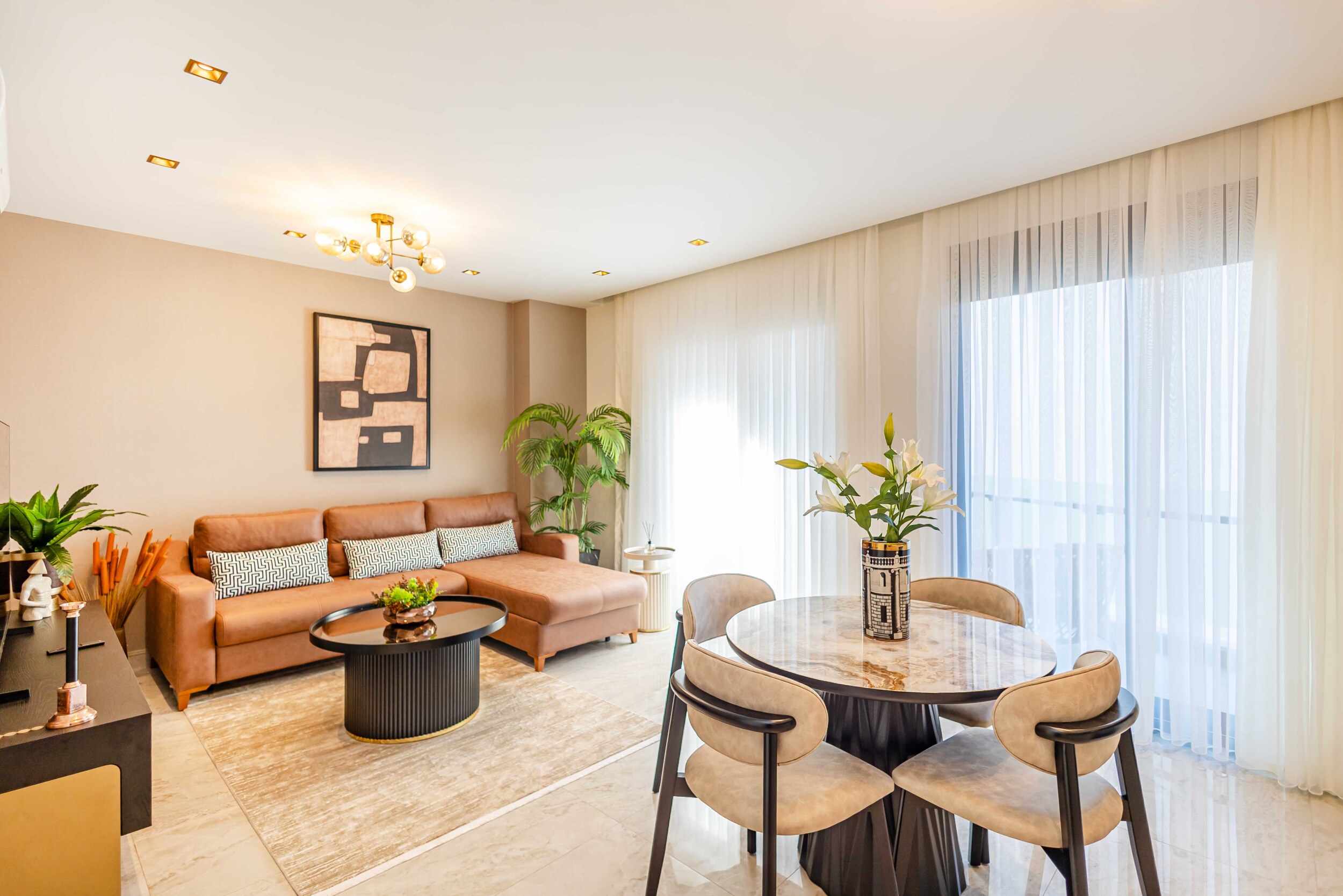 Kitchen-living room with a corner sofa and panoramic glazing by the sea in Turkey