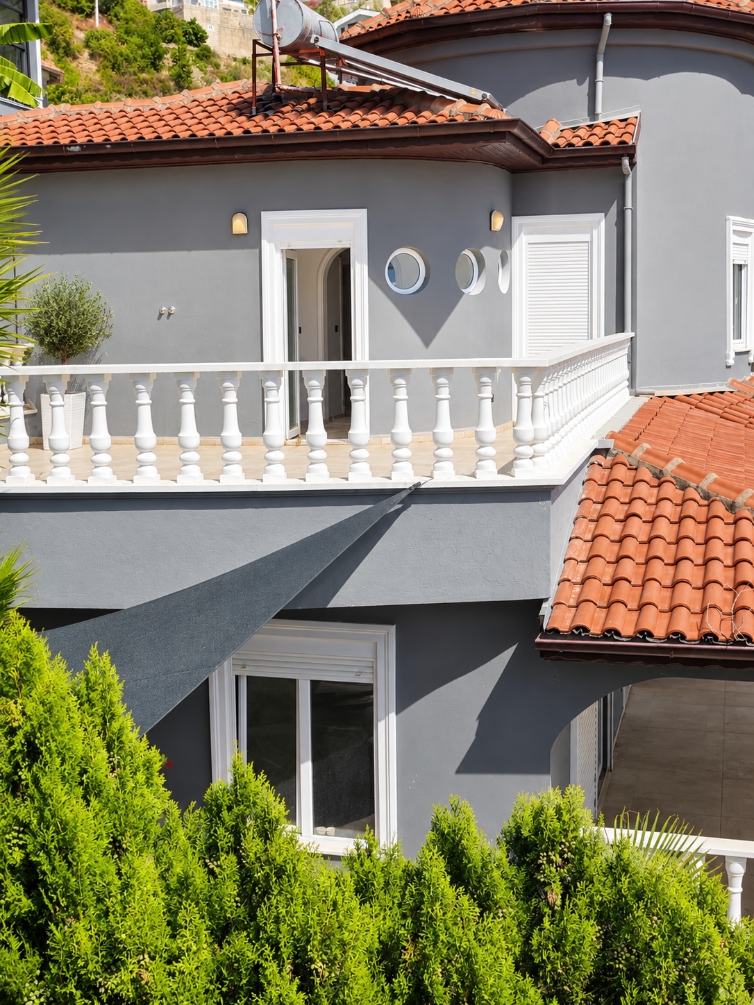 Gray villa facade with red roof: a 3+1 villa for sale in Alanya, Turkey — New Level Group