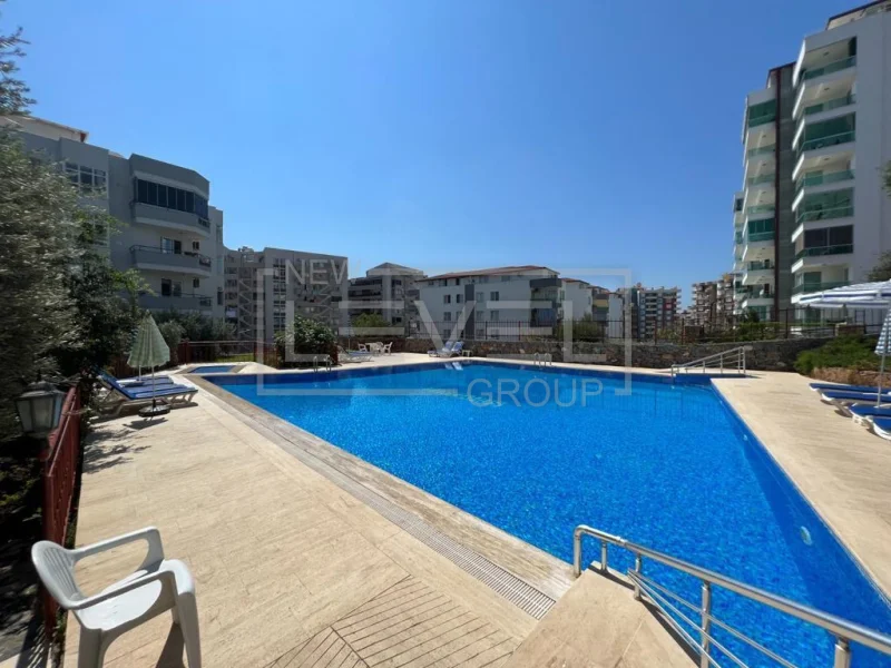 Pool with loungers at a 2+1 apartment residence for sale in Tosmur, Alanya, Turkey — New Level Group