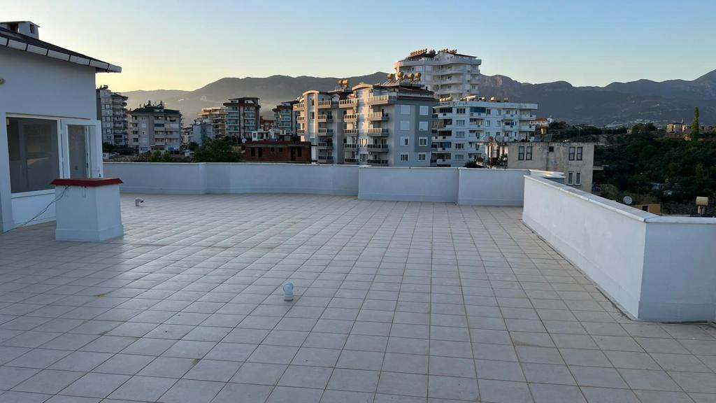 Rooftop terrace with a mountain view in a Tosmur apartment complex where apartments are for sale