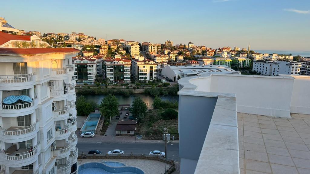 Panoramic city view and pool below from a complex with apartments