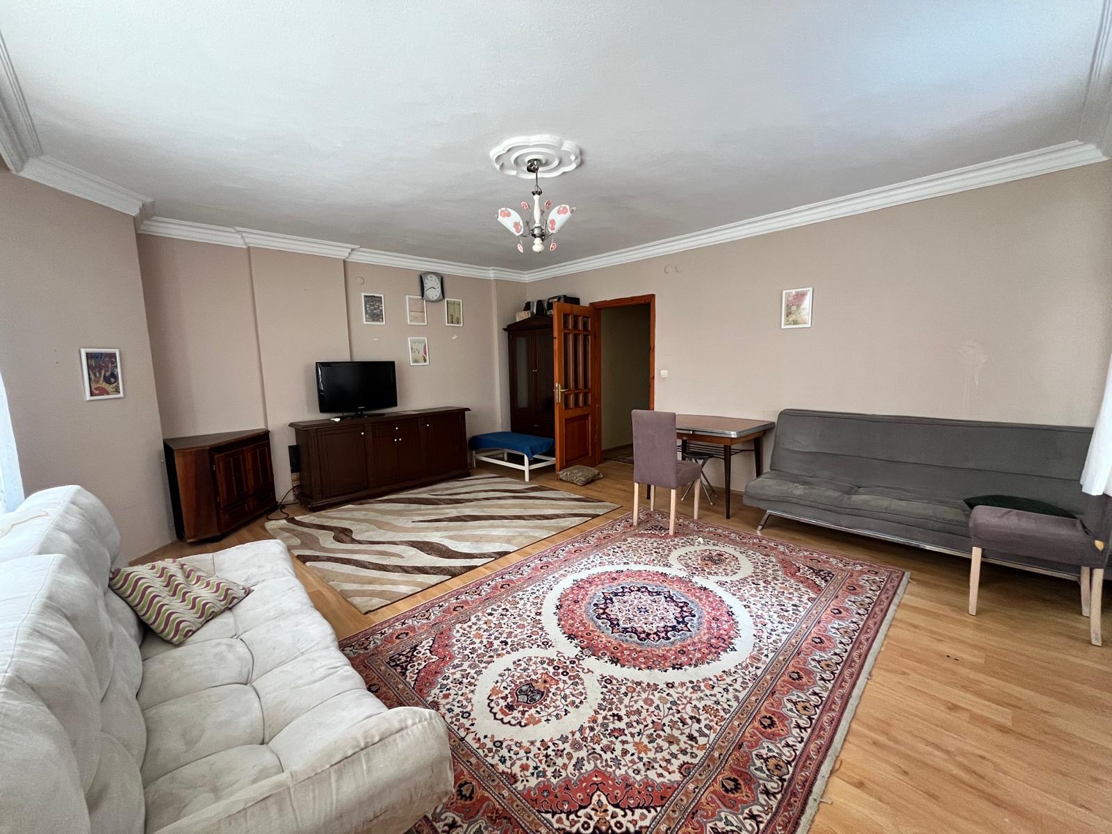 Living room with a corner sofa and dining area in Tosmur where apartments are for sale