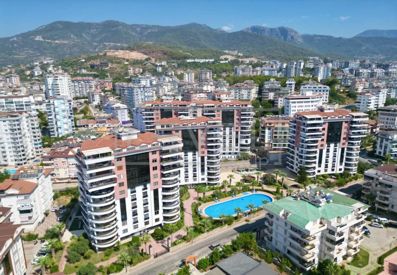 Aerial complex with oval pool and mountains: 4+1 apartment for sale in Cikcilli, Alanya, Turkey — New Level Group