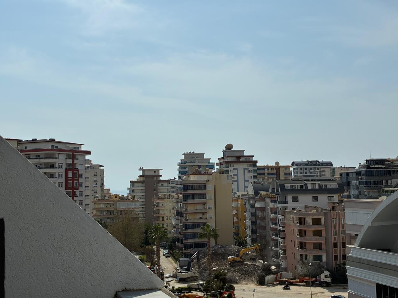 View of dense city buildings and a construction site from the terrace in Mahmutlar