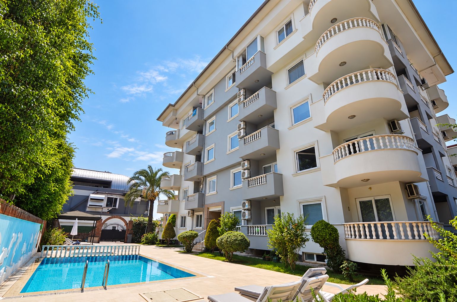 Mavi havuzlu beyaz gri cephe: Çikcilli'de satılık 2+1 daire, Alanya ilçesinde, Türkiye — New Level Group