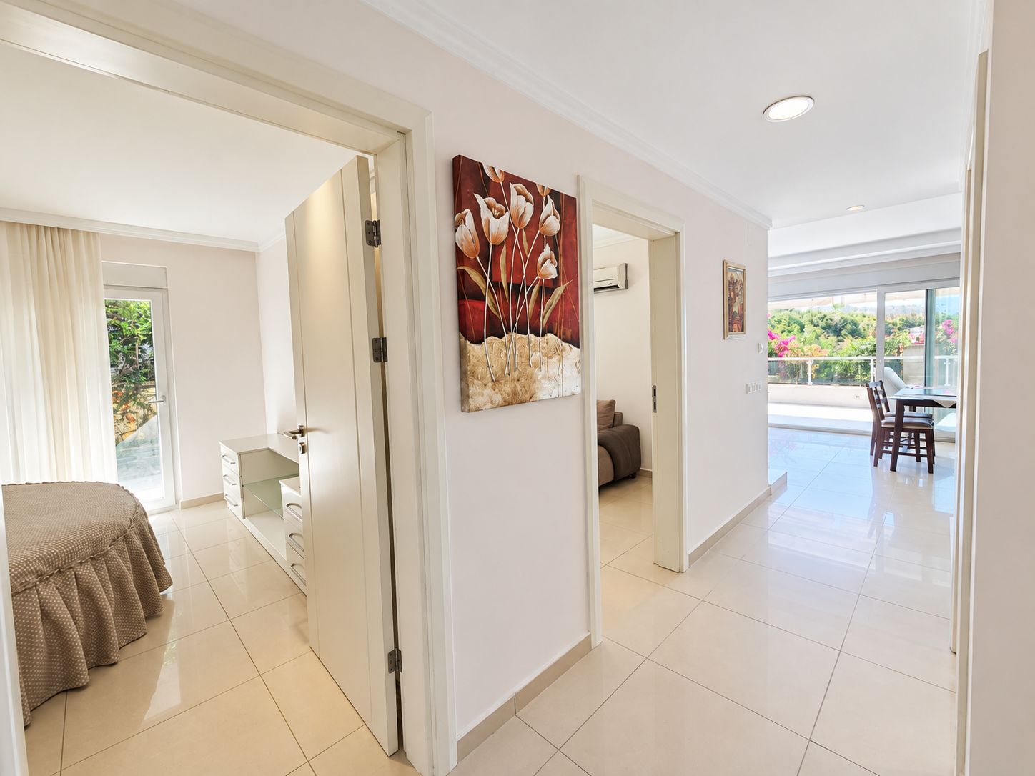 Hall with open white doors, a bedroom view and terrace access in a 2+1 flat in Alanya