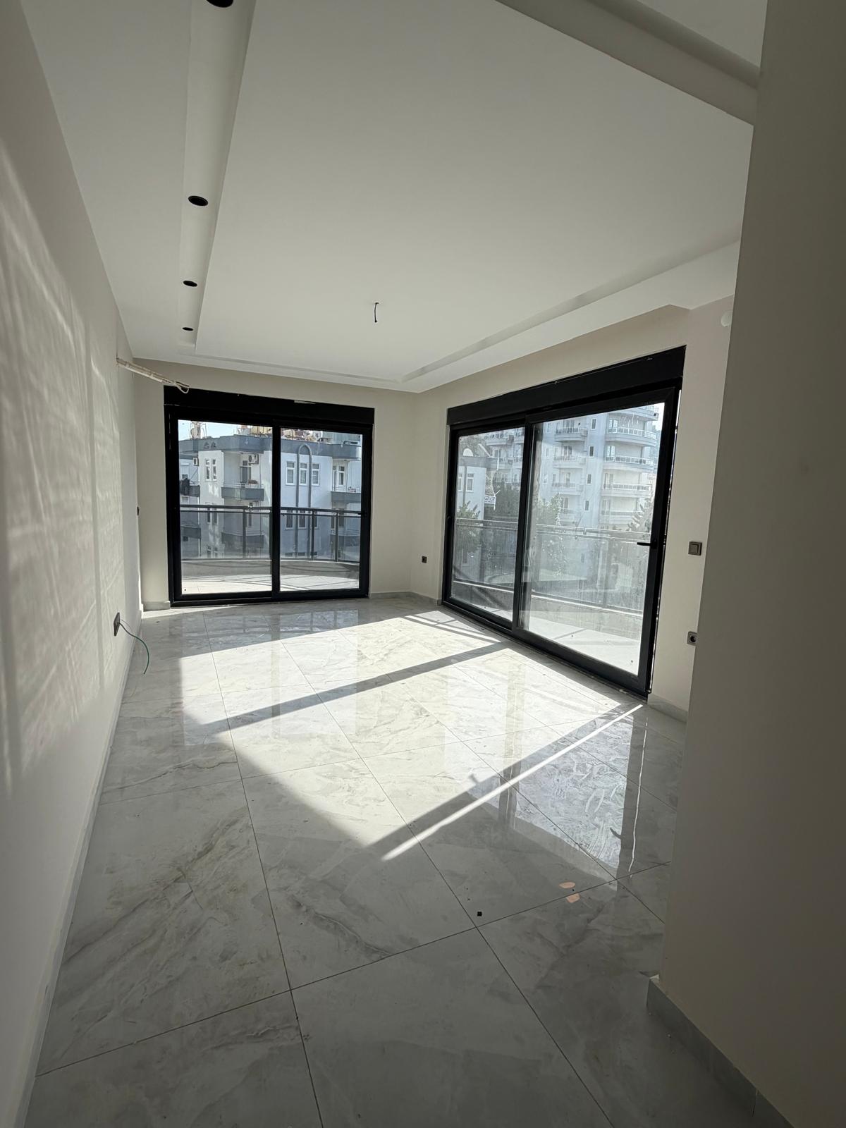Kitchen-living room in a 2+1 flat for sale with corner glazing and glossy marble flooring