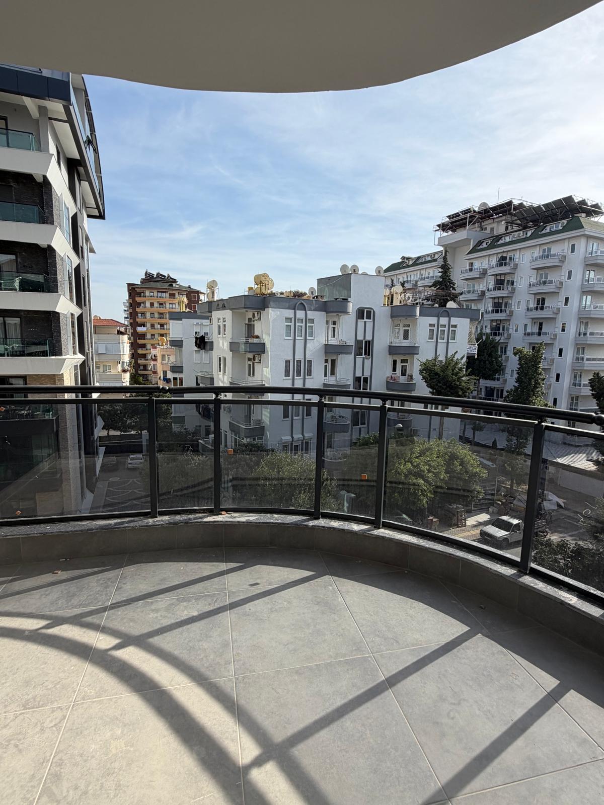 Semicircular balcony with panoramic glazing overlooking city buildings in Turkey