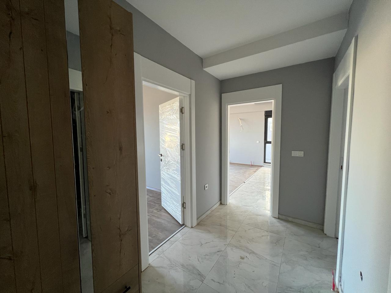 Alanya Konaklı'da deniz manzaralı, modern bir komplekste, şık tasarımlı, yeni 2+1 daire.