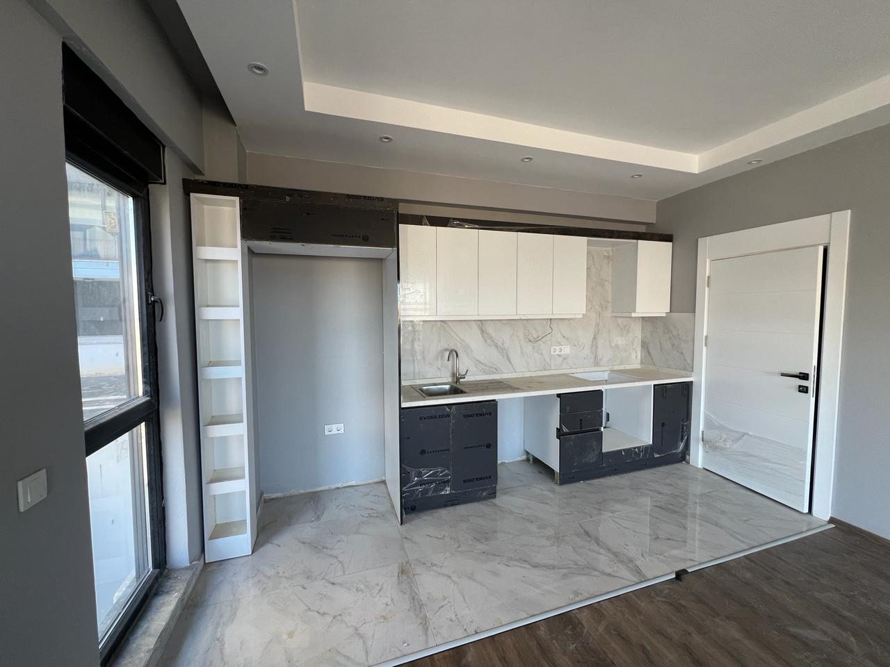 Alanya Konaklı'da deniz manzaralı, modern bir komplekste, şık tasarımlı, yeni 2+1 daire.