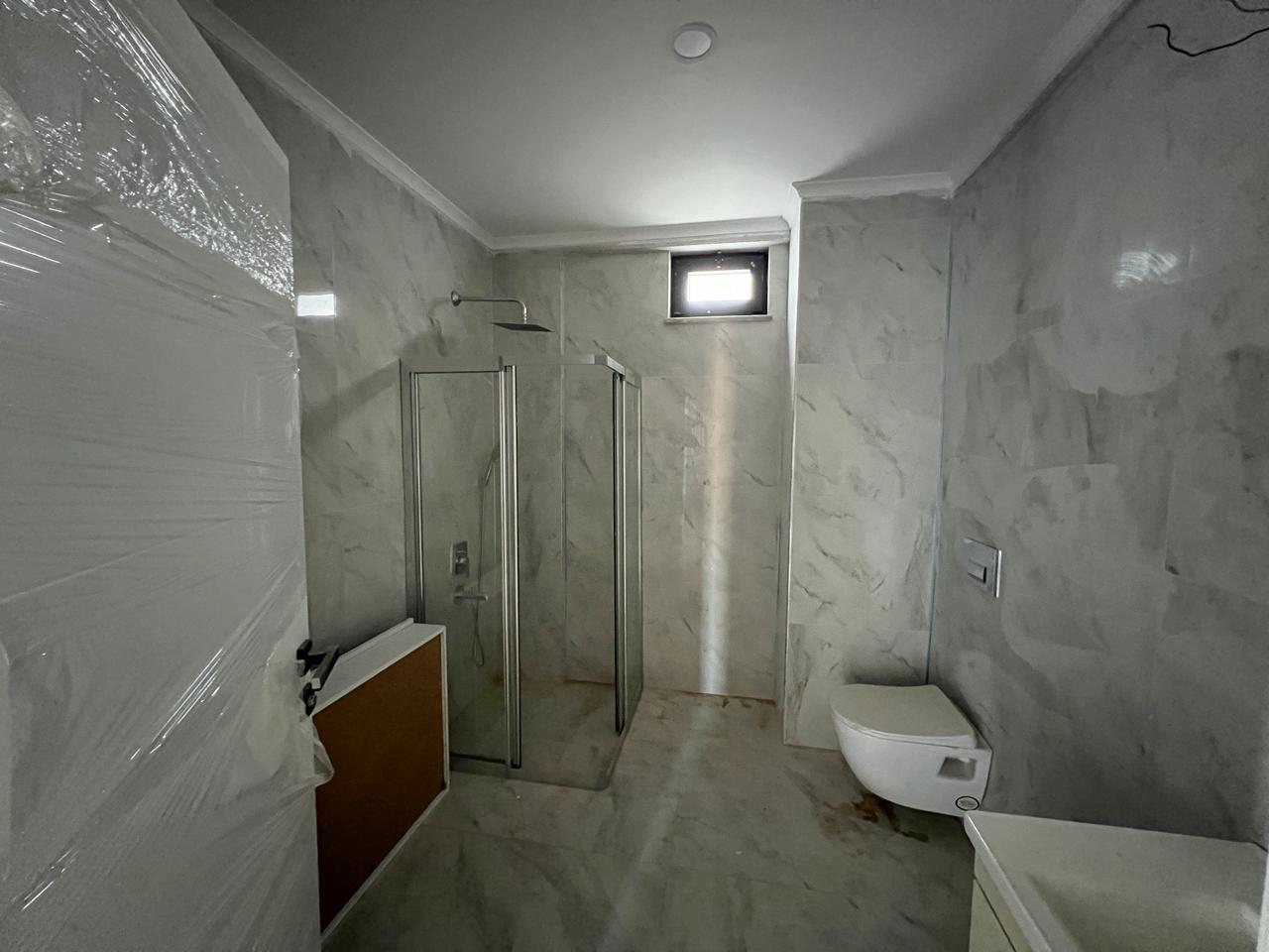 Alanya Konaklı'da deniz manzaralı, modern bir komplekste, şık tasarımlı, yeni 2+1 daire.