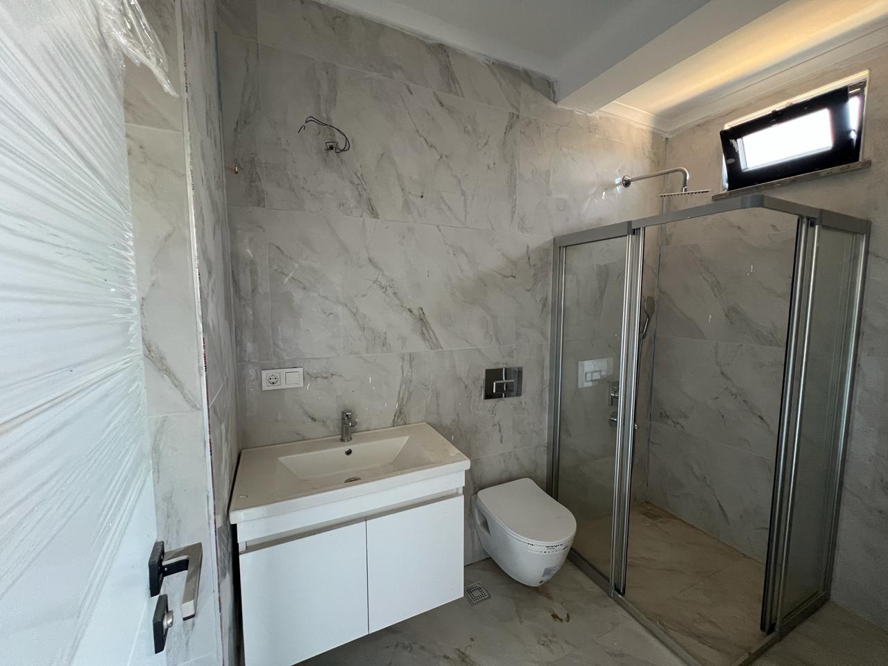 Alanya Konaklı'da deniz manzaralı, modern bir komplekste, şık tasarımlı, yeni 2+1 daire.