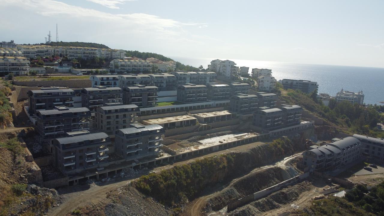 Alanya Konaklı'da deniz manzaralı, modern bir komplekste, şık tasarımlı, yeni 2+1 daire.
