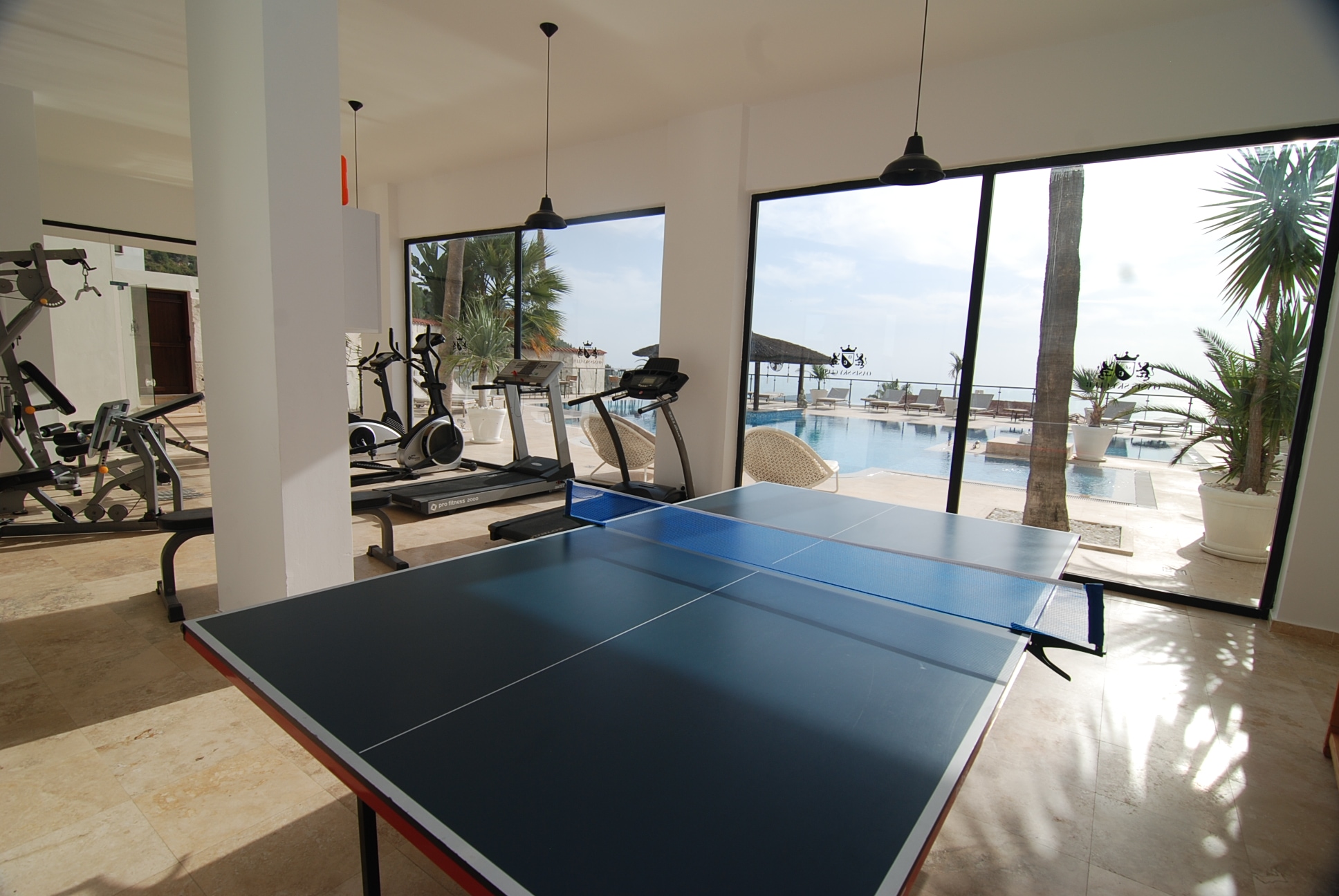 Gym with a table tennis table and cardio equipment overlooking the sea in an Alanya villa