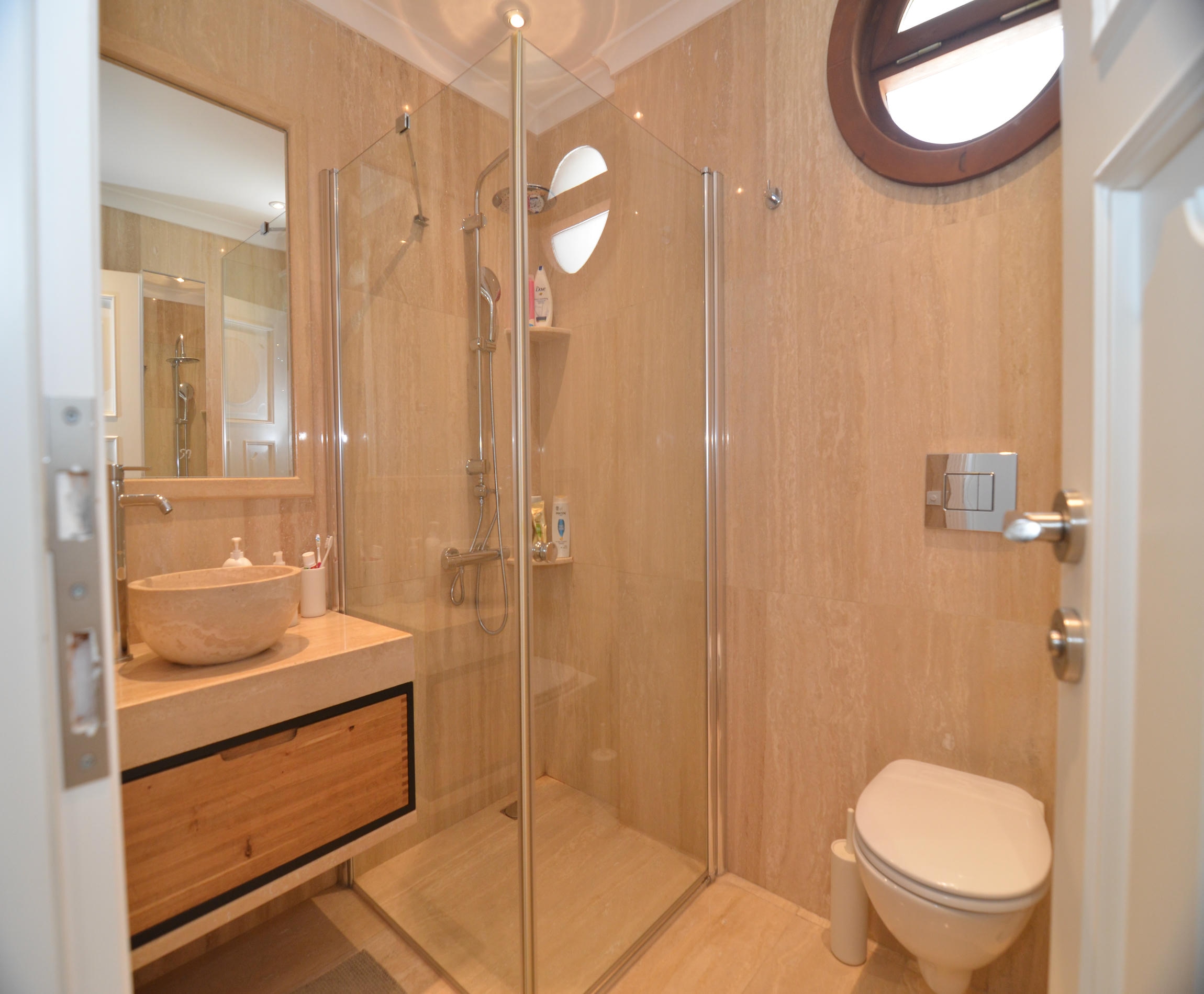 Bathroom with a glass shower cabin and vessel sink in an Alanya villa