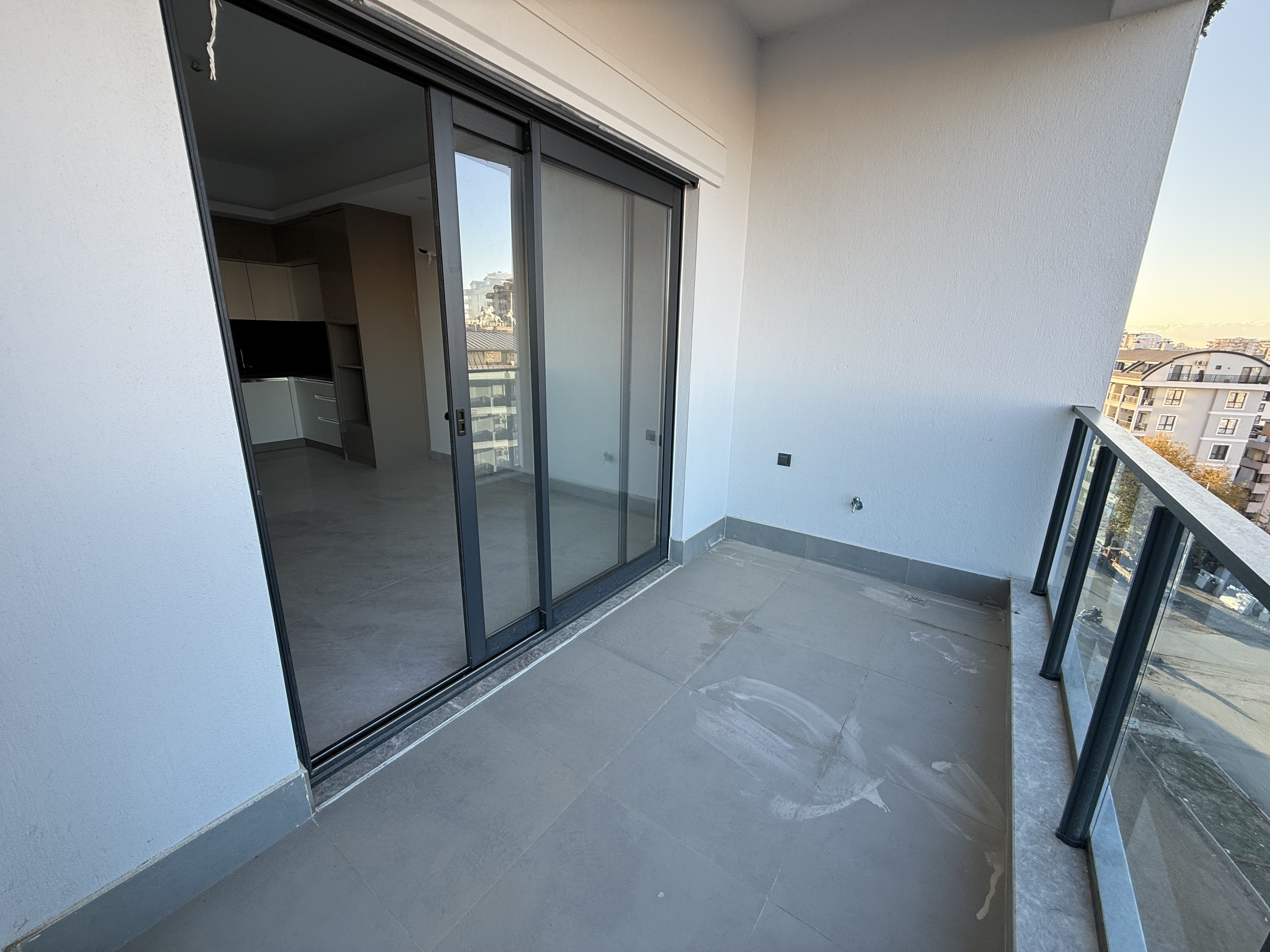 Balcony with panoramic glazing and a glass railing overlooking Mahmutlar