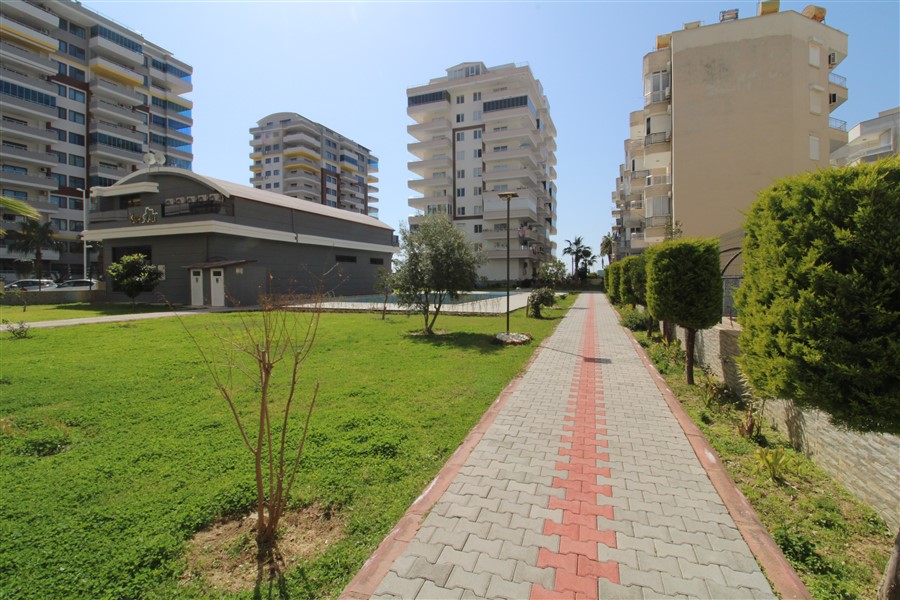 Wide walkway with lawns and trimmed hedges on the grounds of a residence in Turkey