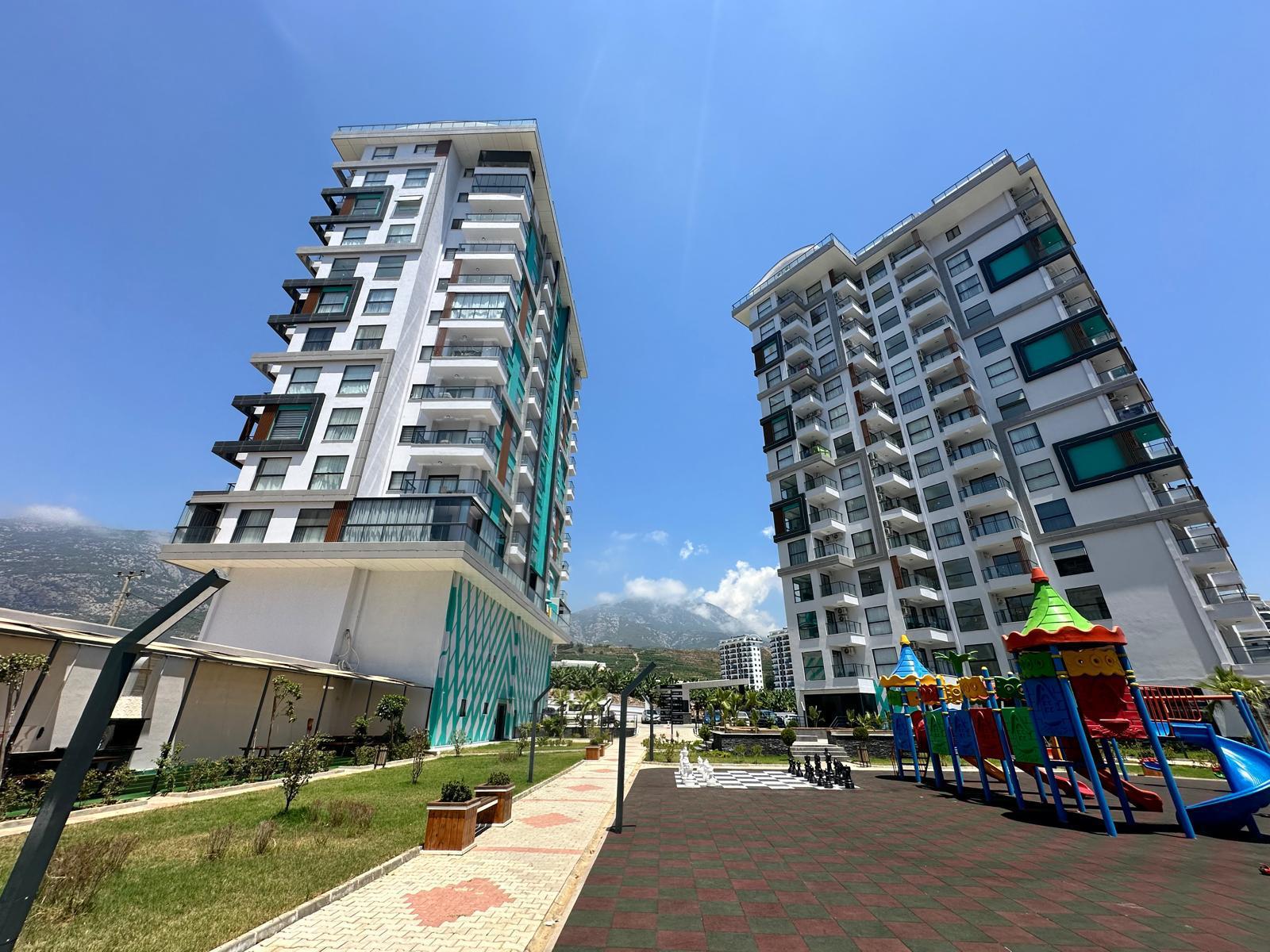 Landscaped walkway and chess area between residential buildings for residents of apartments in Turkey