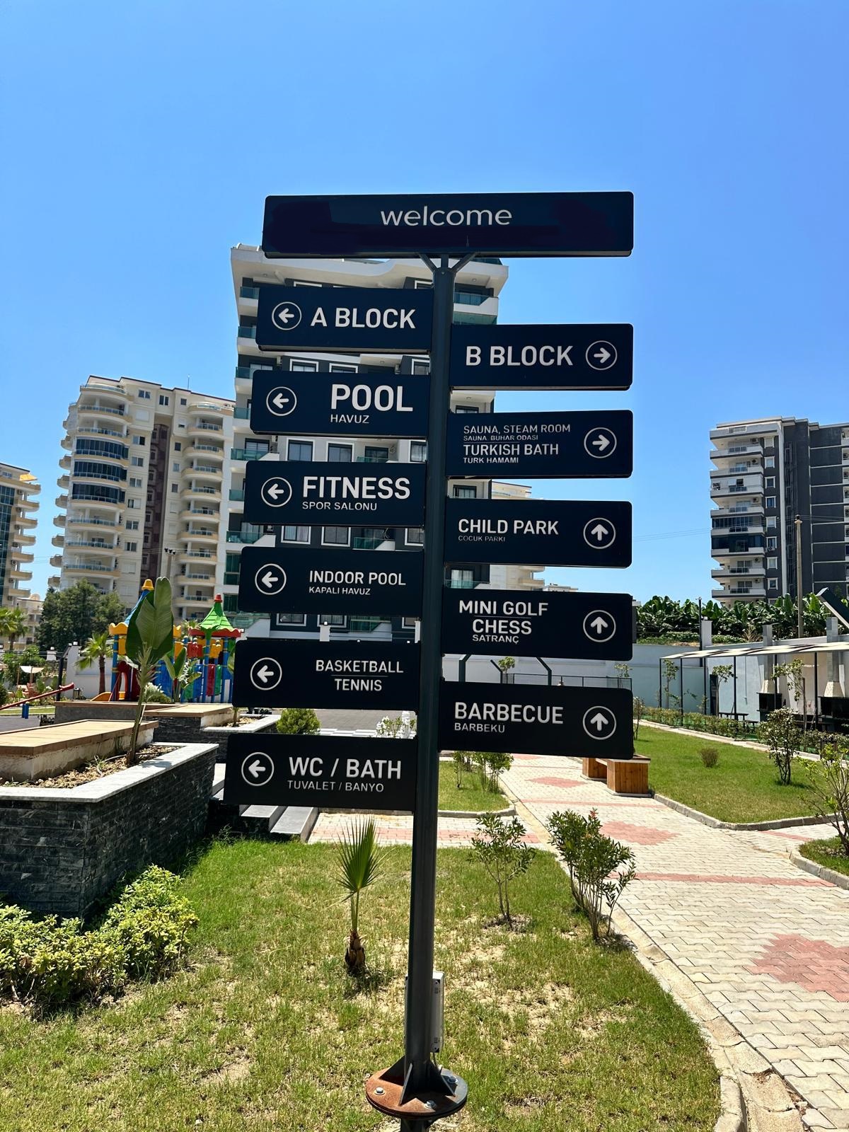Wayfinding signs for the pool, sauna and fitness areas by residential buildings in Turkey with a sale listing