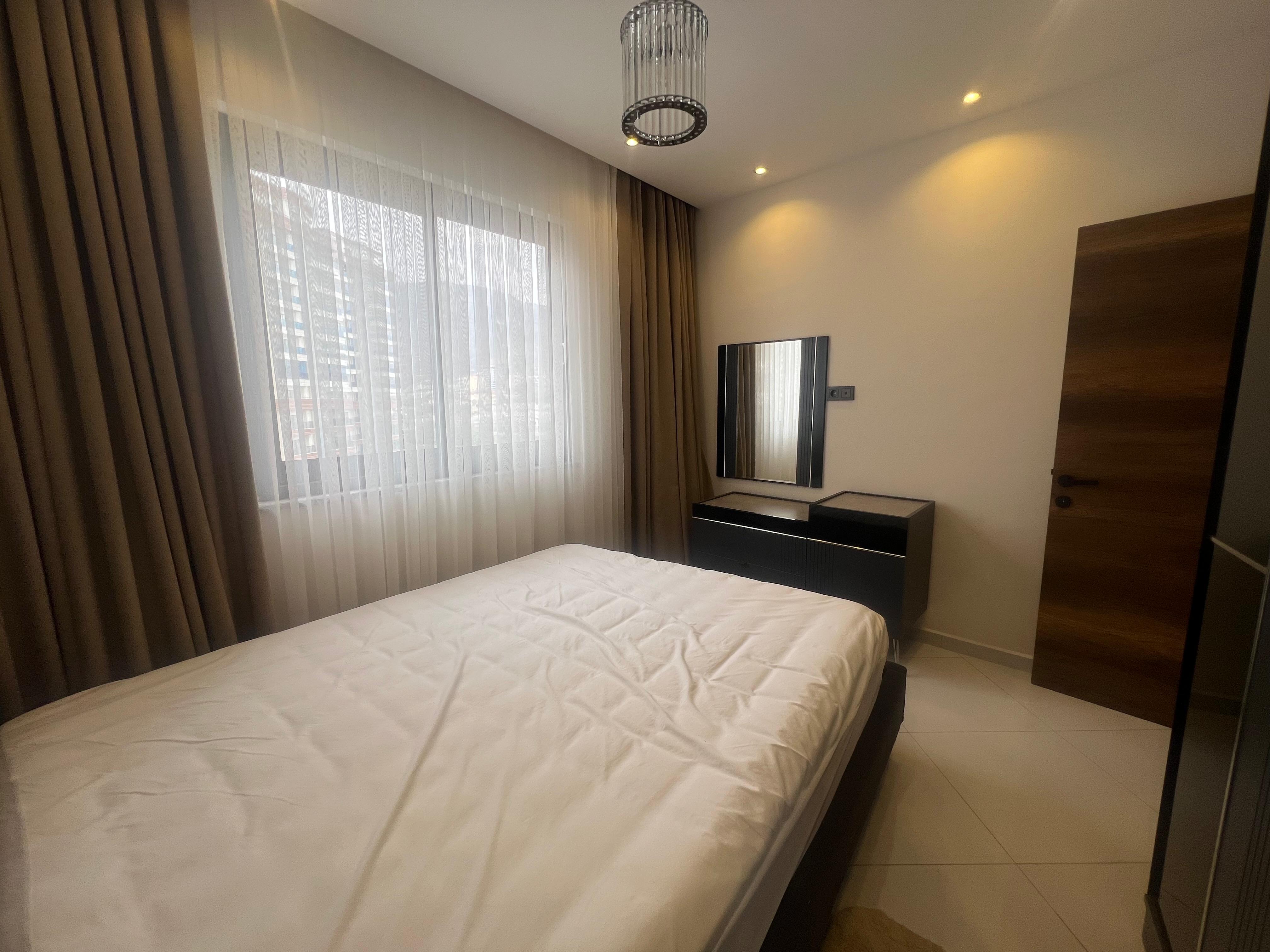 Double bed and built-in wardrobe in a bedroom at the Mahmutlar residence